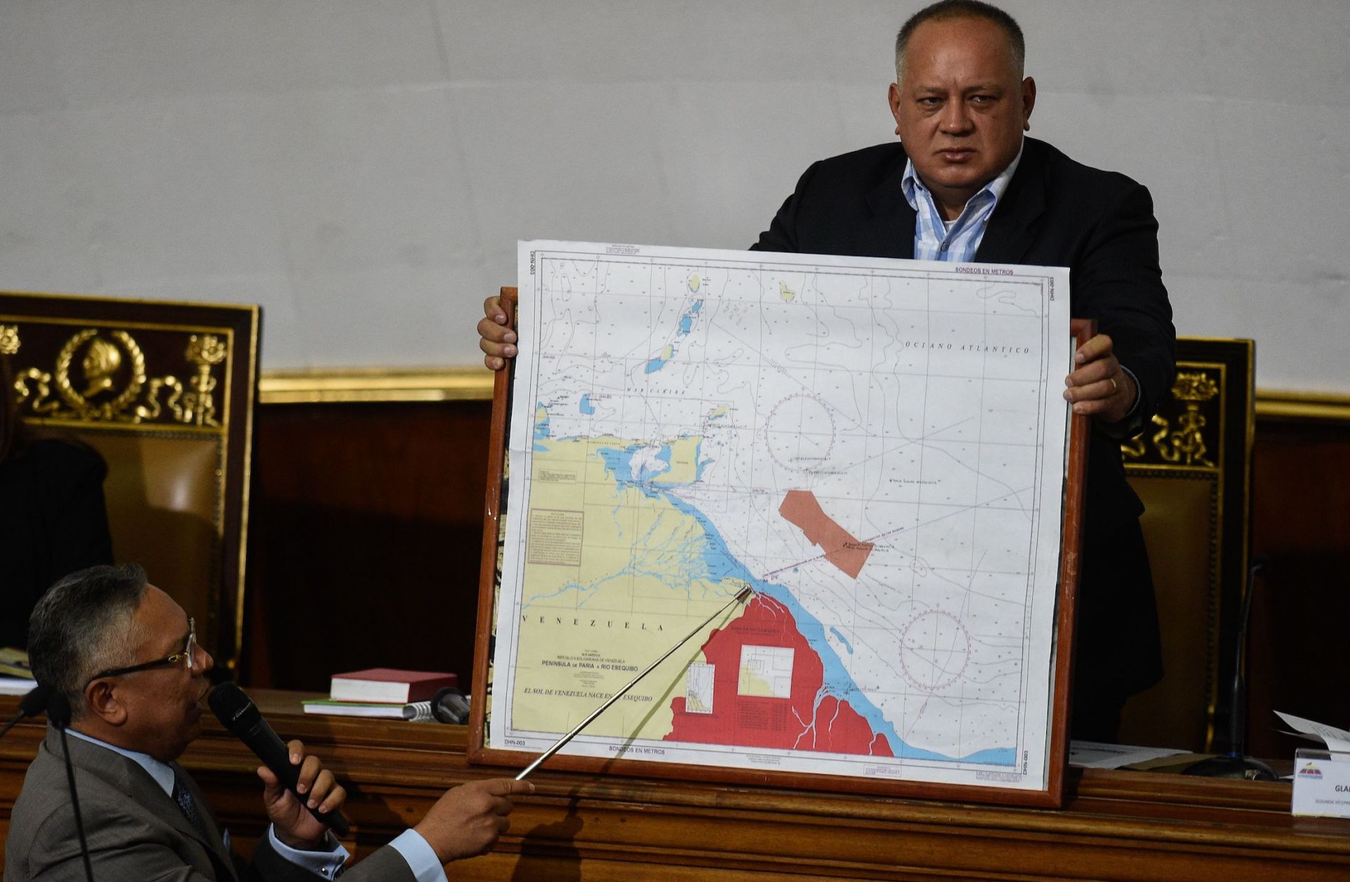 Venezuelan lawmaker Pedro Carreno (L) delivers a speech while Venezuelan deputy Diosdado Cabello (R) holds a map showing the border between Venezuela and Guyana during a legislative session in Caracas on Jan. 8, 2019.