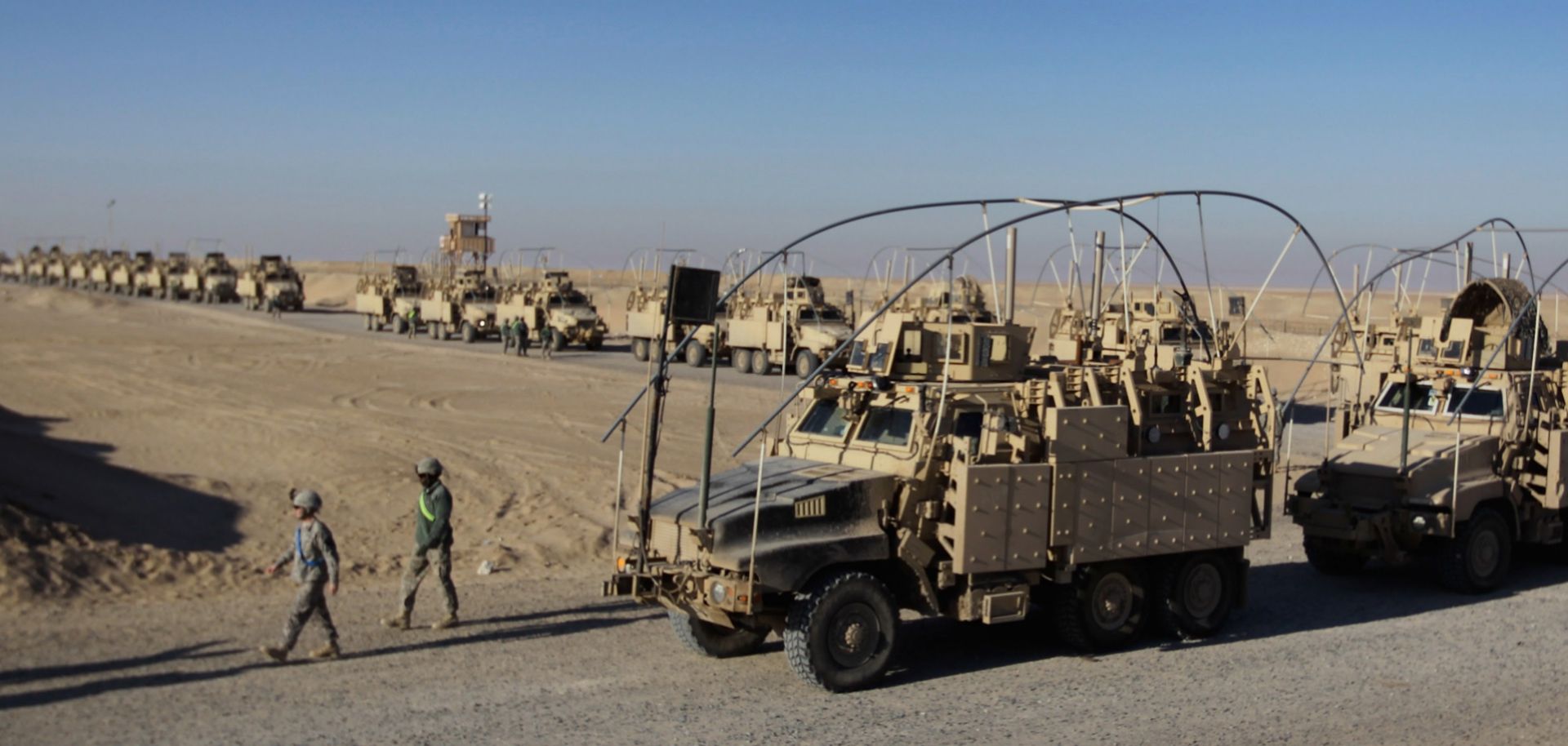 A line of U.S. Army armored vehicles lines up at Camp Virginia near the capital of Kuwait as soldiers pull out of service in Iraq.