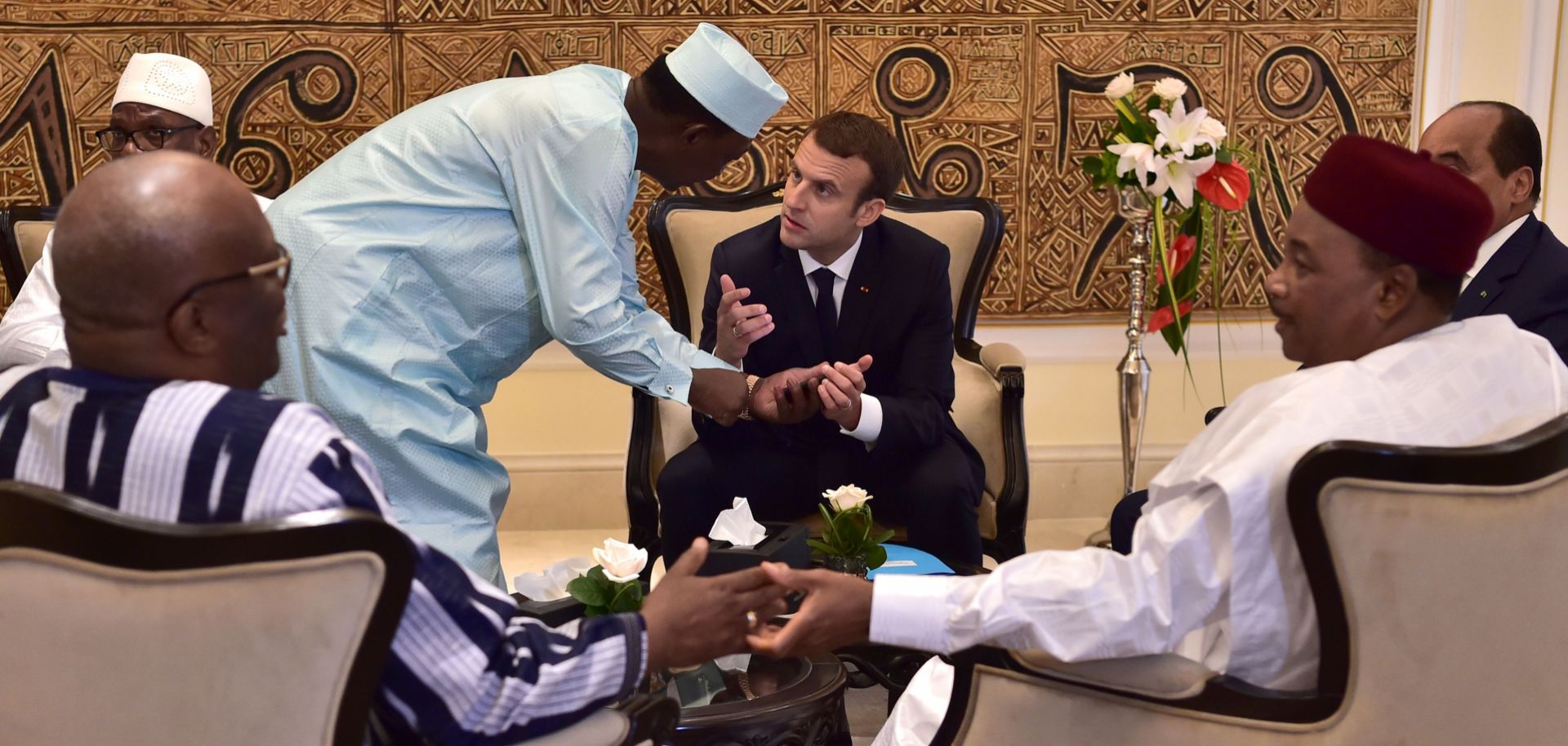 Chad's president Idriss Deby Itno (2nd L) speaks with French President Emmanuel Macron (C) as they gather with President of Burkina Faso Roch Marc Christian Kabore (front L), Mali's President Ibrahim Boubacar Keita (rear L), Niger's President Mahamadou Issoufou (front R) and Mauritanian President Mohamed Ould Abdel Aziz (rear R) for a meeting during the G5 Sahel summit in Bamako, July 2. 