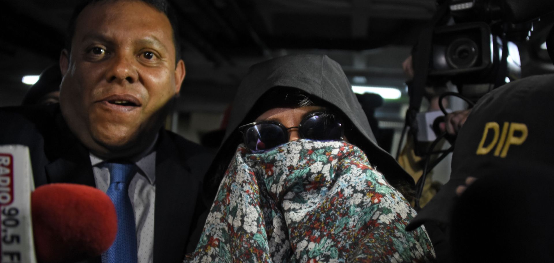 Guatemalan police officers escort former presidential candidate Sandra Torres to the Supreme Court in Guatemala City on Sept. 2, 2019, following her arrest on corruption charges.