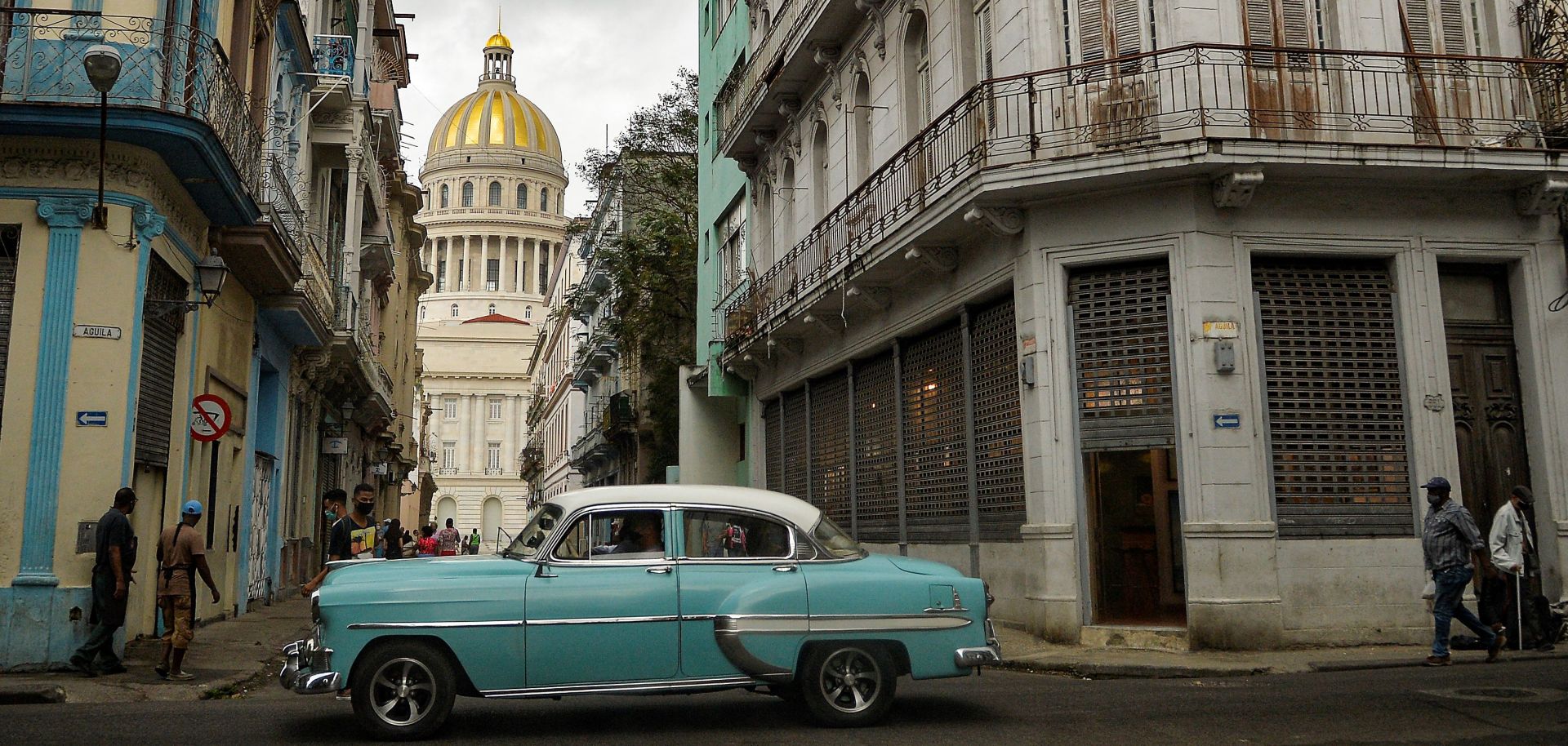 An old American car passes by the capitol building in Havana, Cuba, on May 3, 2021. 