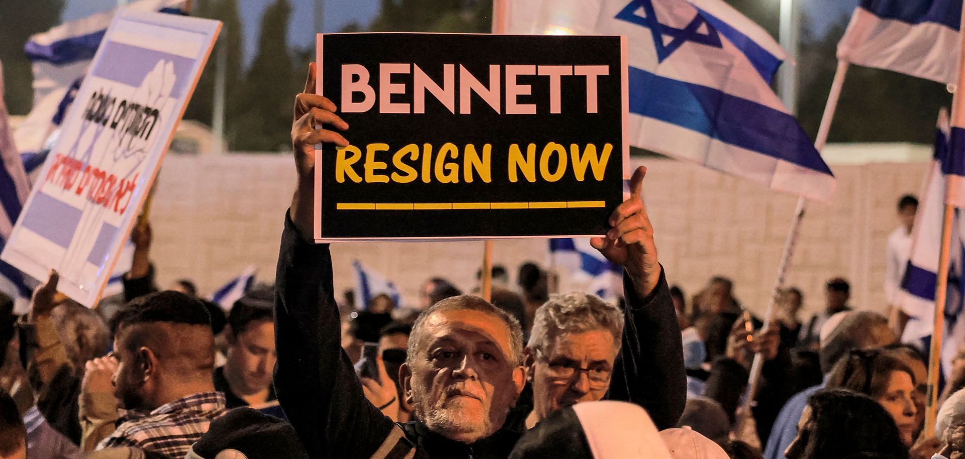 A man holds up a sign during an anti-government protest staged by Israeli right-wing supporters in Jerusalem, Israel, on April 6, 2022. 