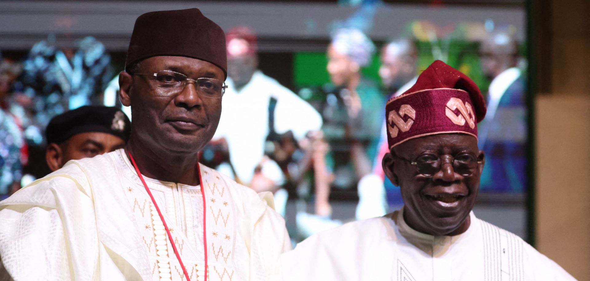 Nigerian President-elect Bola Tinubu (right) and the chairman of the country's Independent National Election Commission (INEC), Yakubu Mahmood, look on during a ceremony in Abuja on March 1, 2023. 