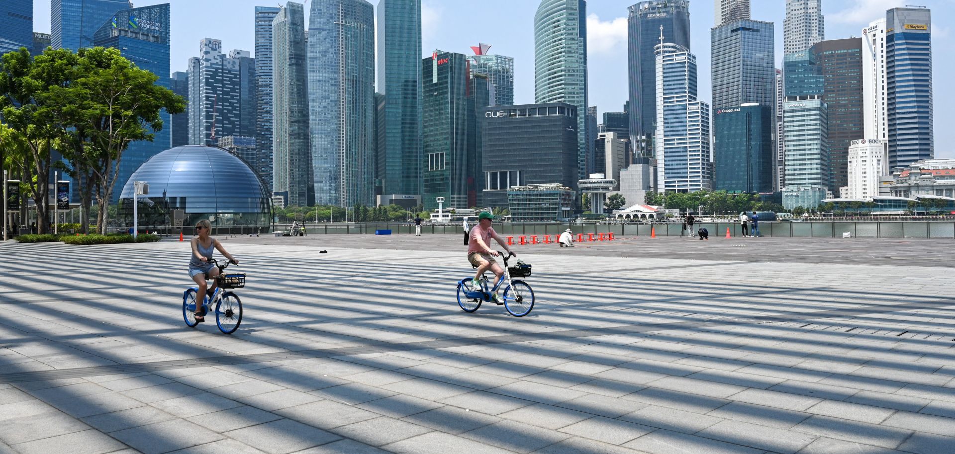 People cycle along the promenade at Marina Bay in Singapore on Oct. 13, 2023. 