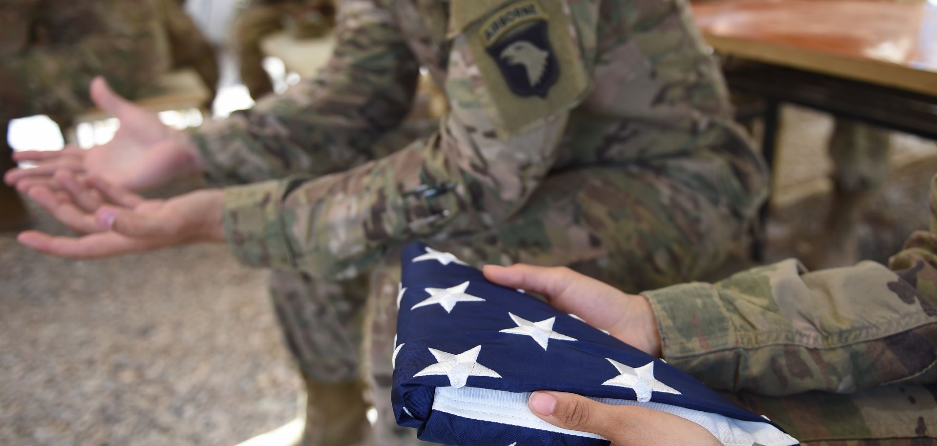 A U.S. soldier holds the national flag ahead of a handover ceremony at CampLeatherneck in Lashkar Gah in the Afghan province of Helmand on April 29.