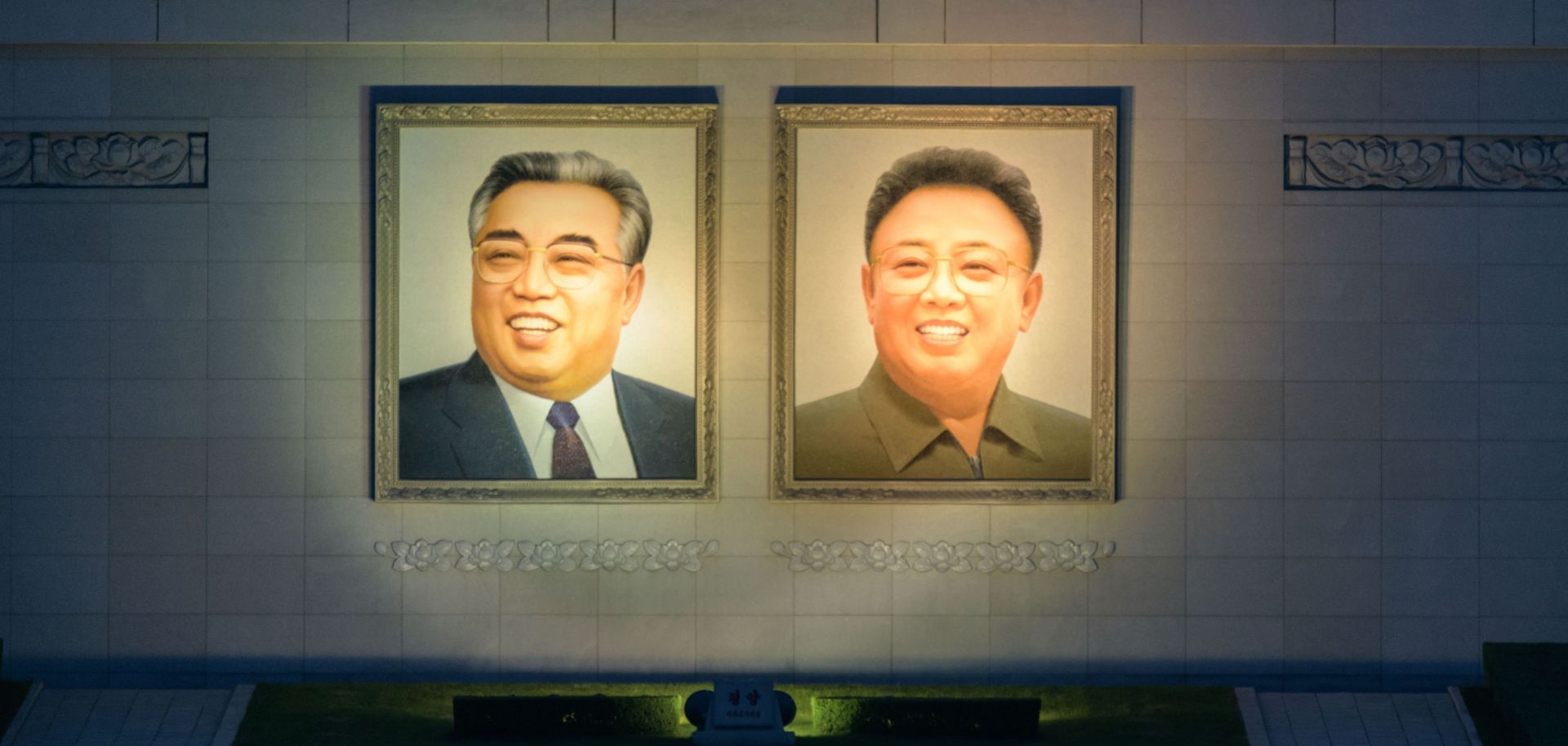 The portraits of late North Korean leaders Kim Il Sung (L) and Kim Jong Il are displayed in Kim Il Sung square in central Pyongyang on June 12, 2018.