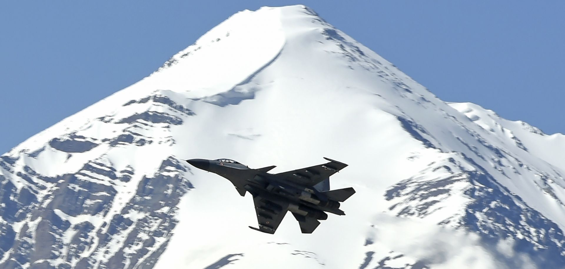 An Indian fighter jet flies over a mountain range near the disputed territory of Ladakh on June 23, 2020. 