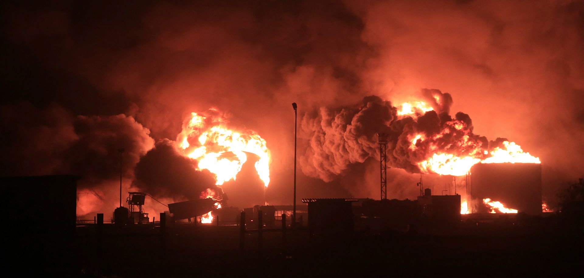 A giant fire erupts at an oil storage facility following Israeli strikes in Yemen's Houthi-held port city of Hodeida on July 20, 2024. 