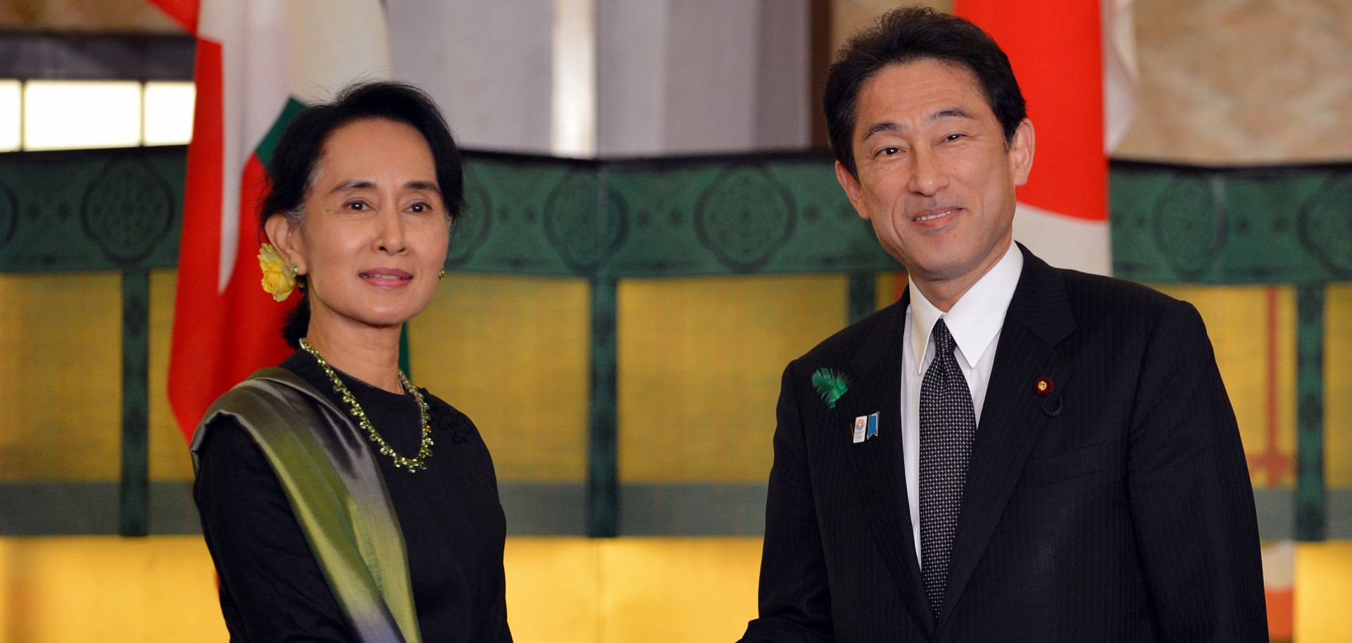 Myanmar's democracy leader Aung San Suu Kyi (L) shakes hands with Japanese Foreign Minister Fumio Kishida prior to their talks at the Iikura guesthouse in Tokyo on April 16, 2013.