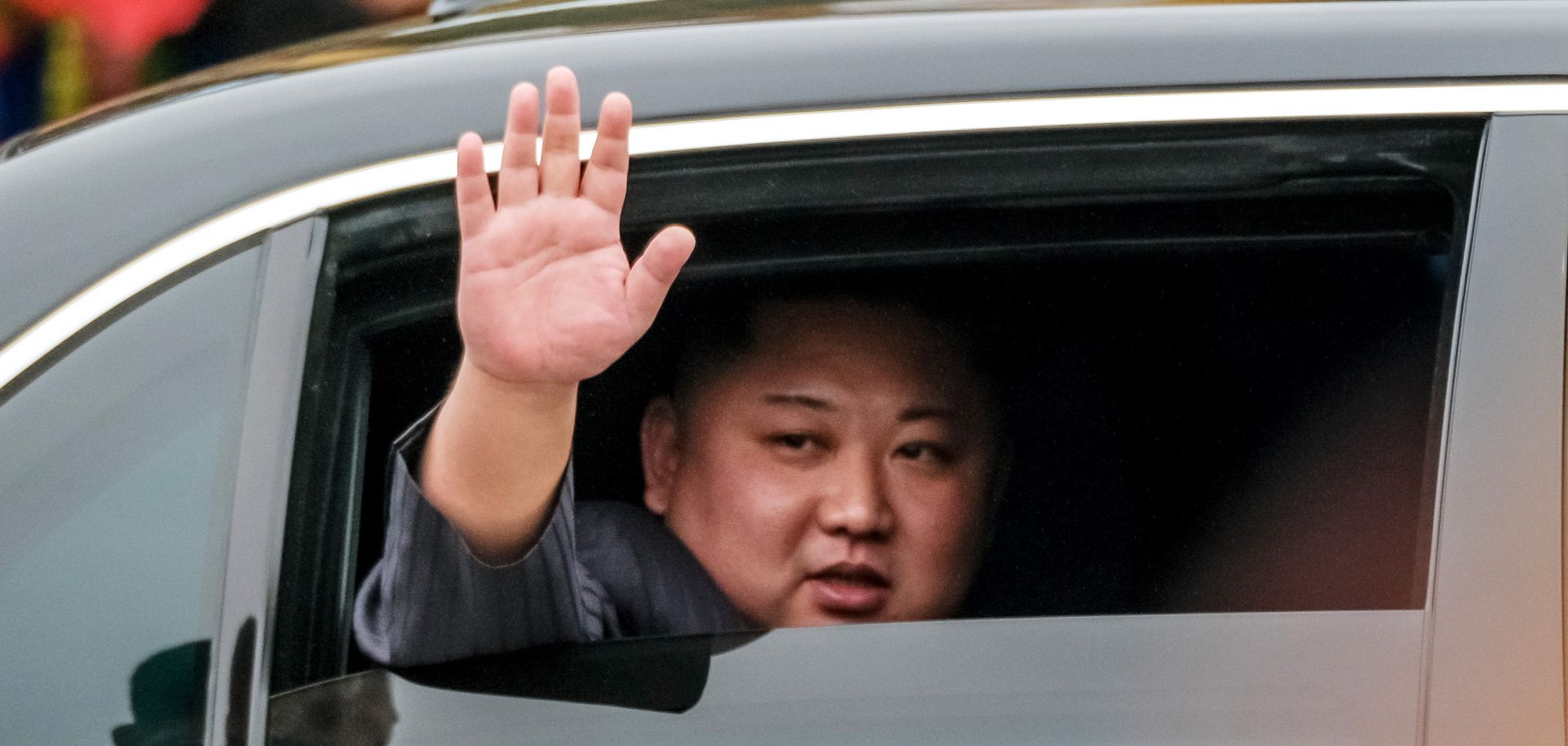 North Korean leader Kim Jong Un waves from his car after arriving in Vietnam on Feb. 26, 2019.