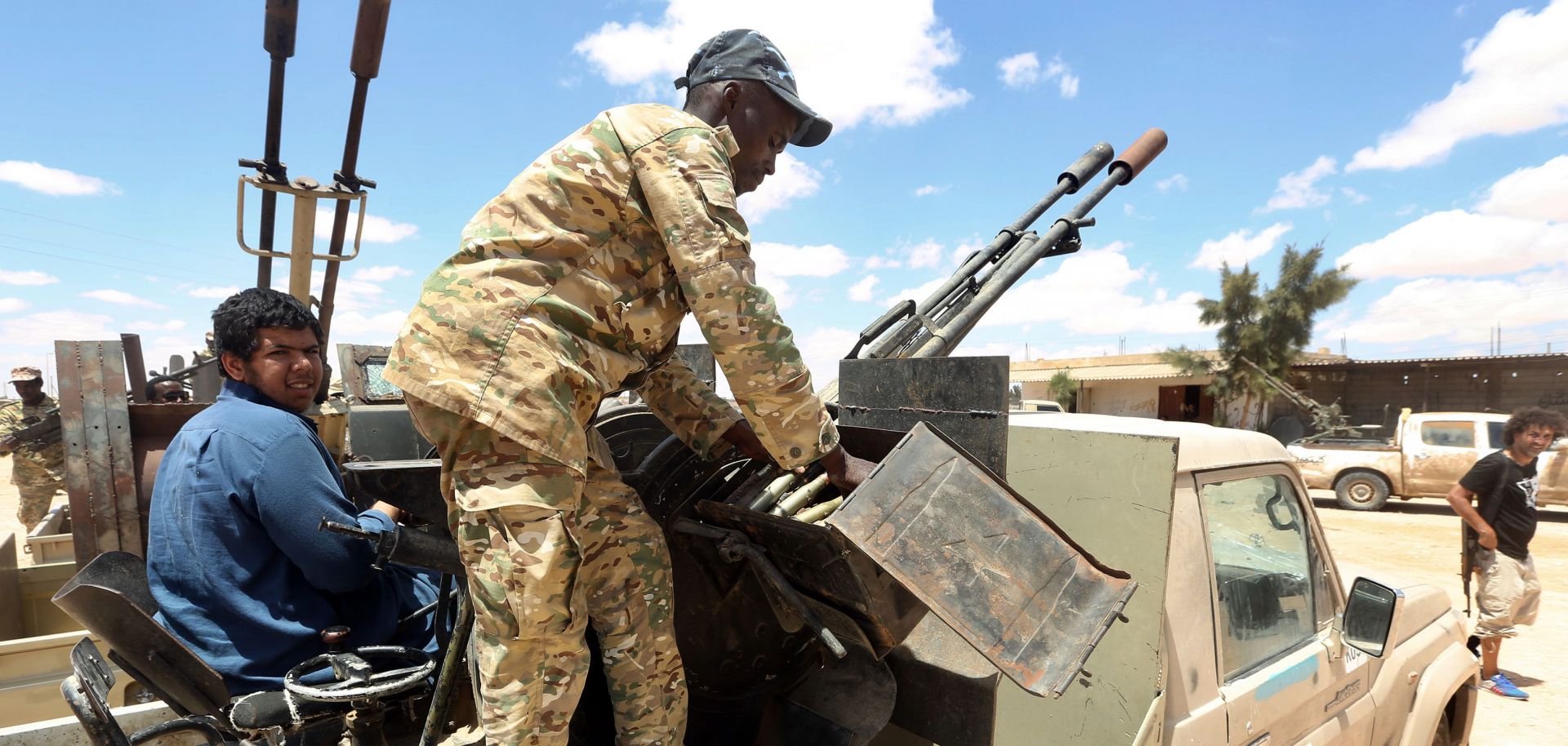 Fighters aligned with Libya's internationally-recognized Government of National Accord (GNA) patrol a village located halfway between Tripoli and Benghazi on July 20, 2020.