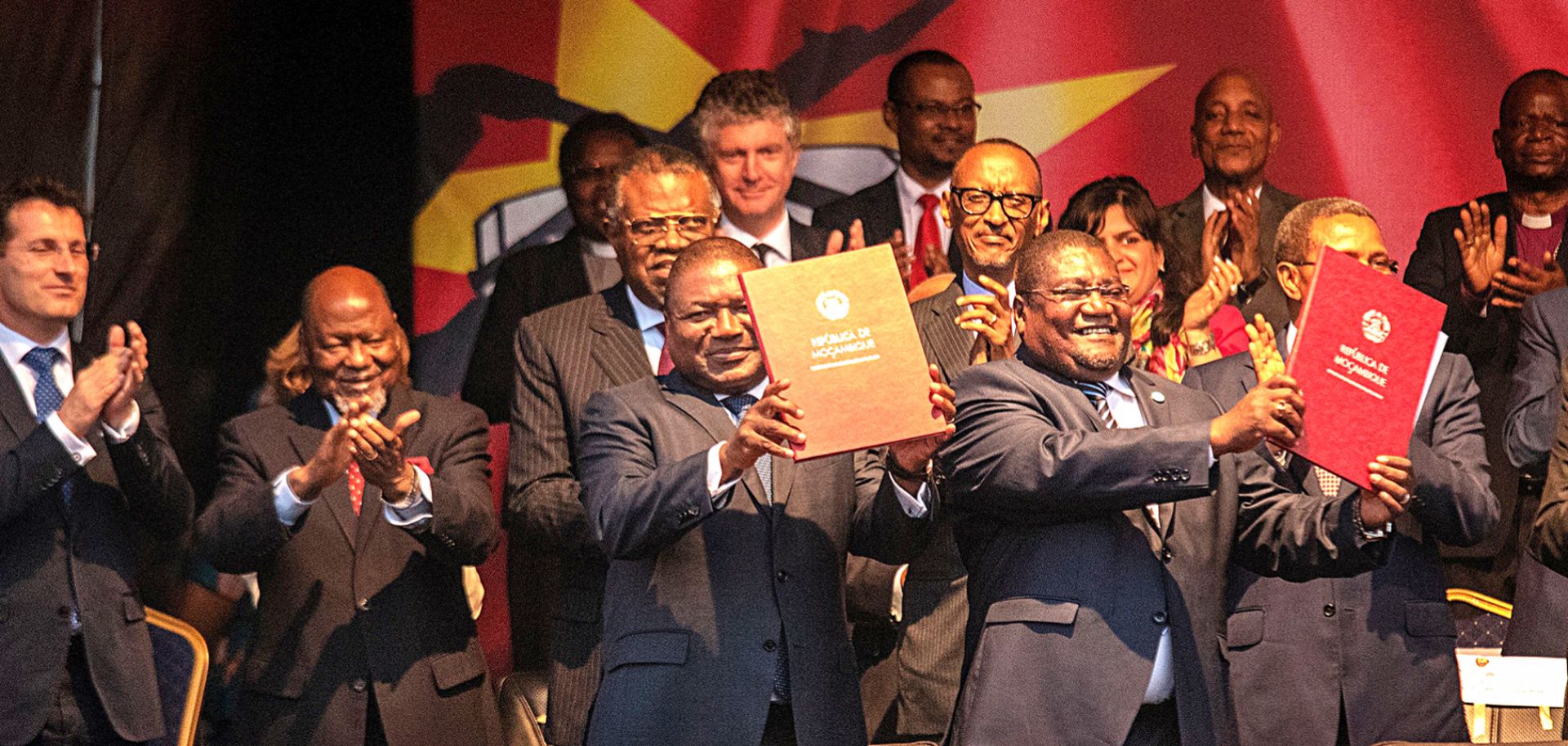 Mozambican President Filipe Nyusi (left) and Mozambican National Resistance leader Ossufo Momade display the cease-fire agreement they signed in Maputo on Aug. 6, 2019.