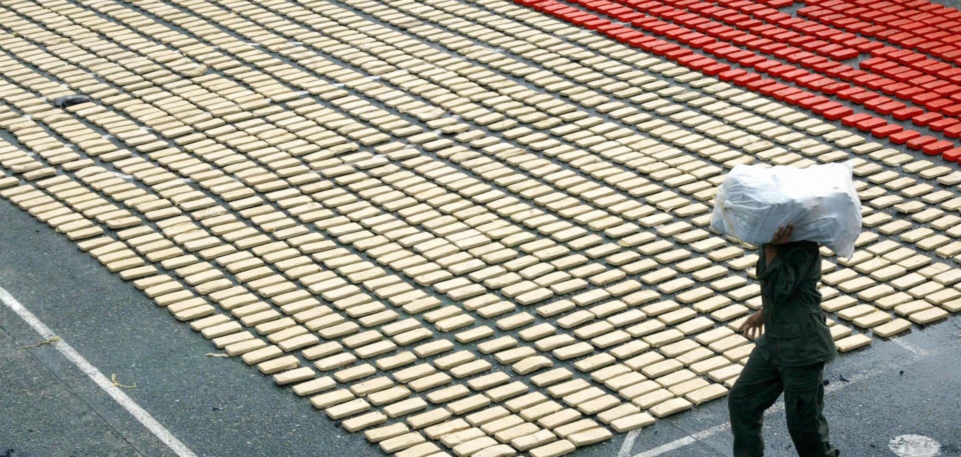 A narcotic policeman organizes 3.1 tons of hydrochloride of cocaine seized in the port of Buenaventura, Valle del Cauca department, Colombia.