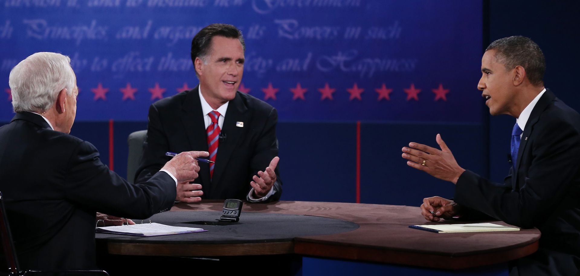 U.S. President Barack Obama (R) debates with Republican presidential candidate Mitt Romney as moderator Bob Schieffer (L) of CBS looks on at the Keith C. and Elaine Johnson Wold Performing Arts Center at Lynn University on October 22, 2012 in Boca Raton, Florida.