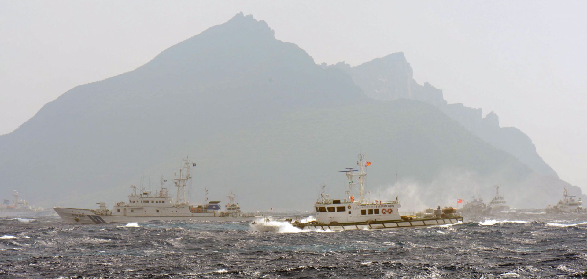 A Taiwan Coast Guard boat (R-with red flag) is blocked by a Japan Coast Guard vessel (L) in the waters near the disputed Diaoyu / Senkaku islands in the East China Sea on September 25, 2012.