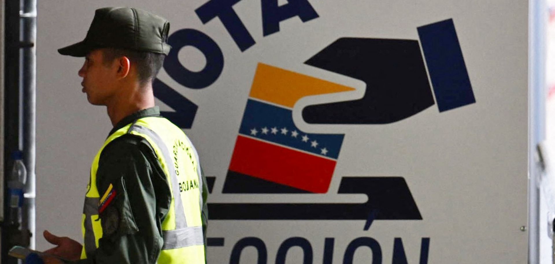 A member of Venezuela’s national guard walks past the information center of the country’s National Electoral Council (CNE) in Caracas on July 16, 2024, ahead of the upcoming presidential election.