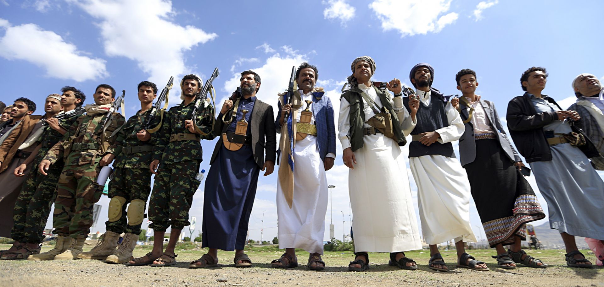 Armed men gather to protest against the Saudi-led intervention in Yemen.