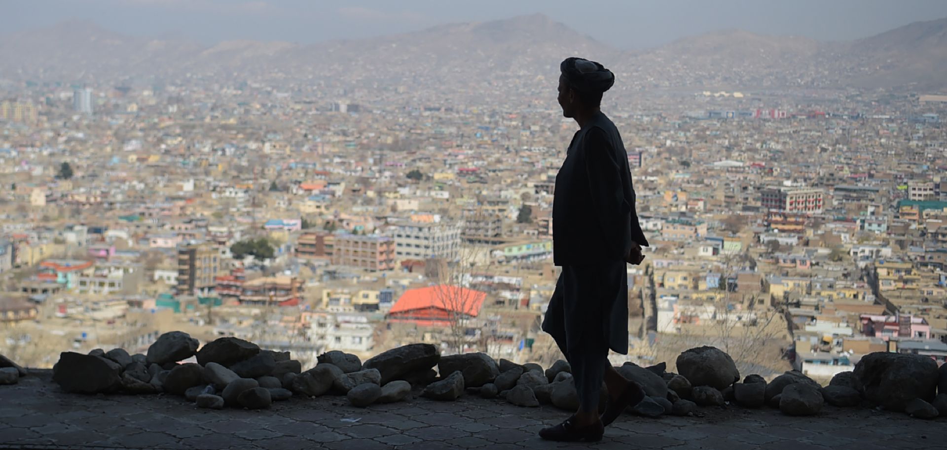 An Afghan man walks along a hilltop overlooking Kabul on March 21, 2018.