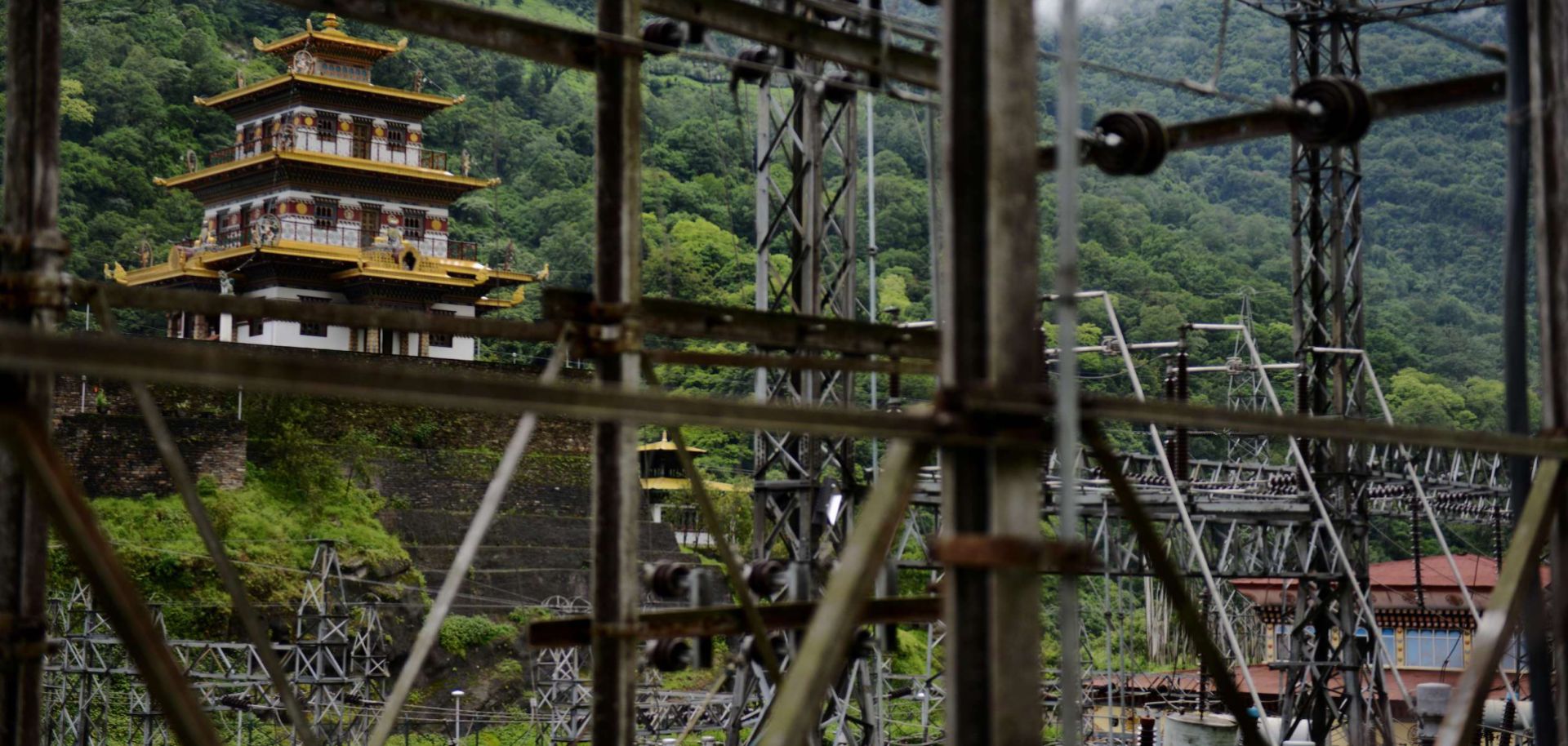 A Buddhist temple sits near a hydroelectric grid main in southeastern Bhutan in 2013.