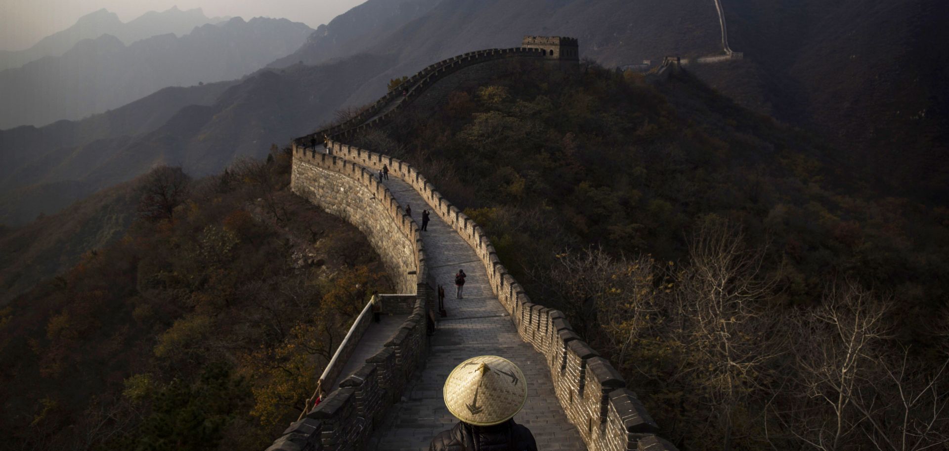 Tourists walk down part of the Great Wall of China.