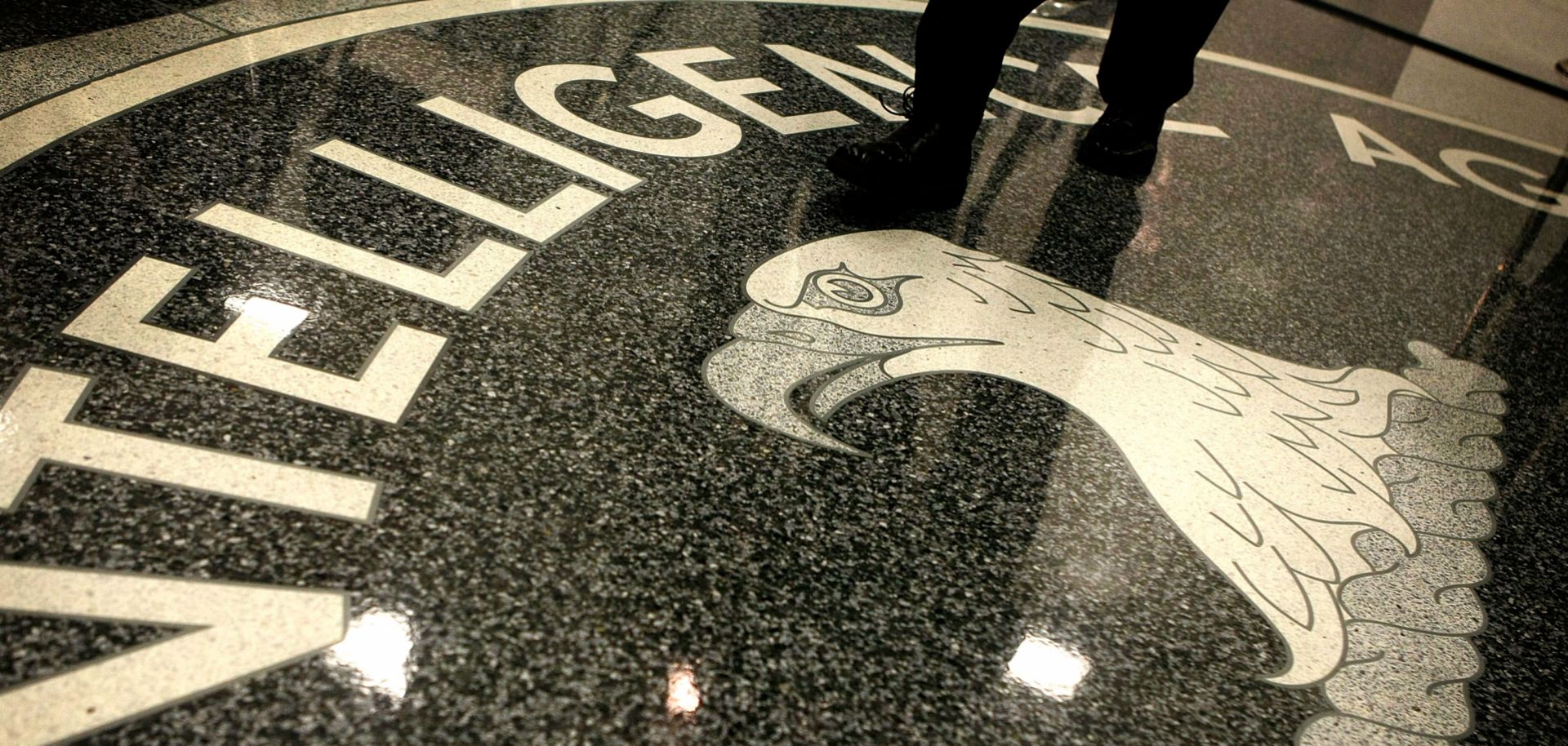 A man walks across the seal of the Central Intelligence Agency at the lobby of the Original Headquarters Building at the CIA headquarters.