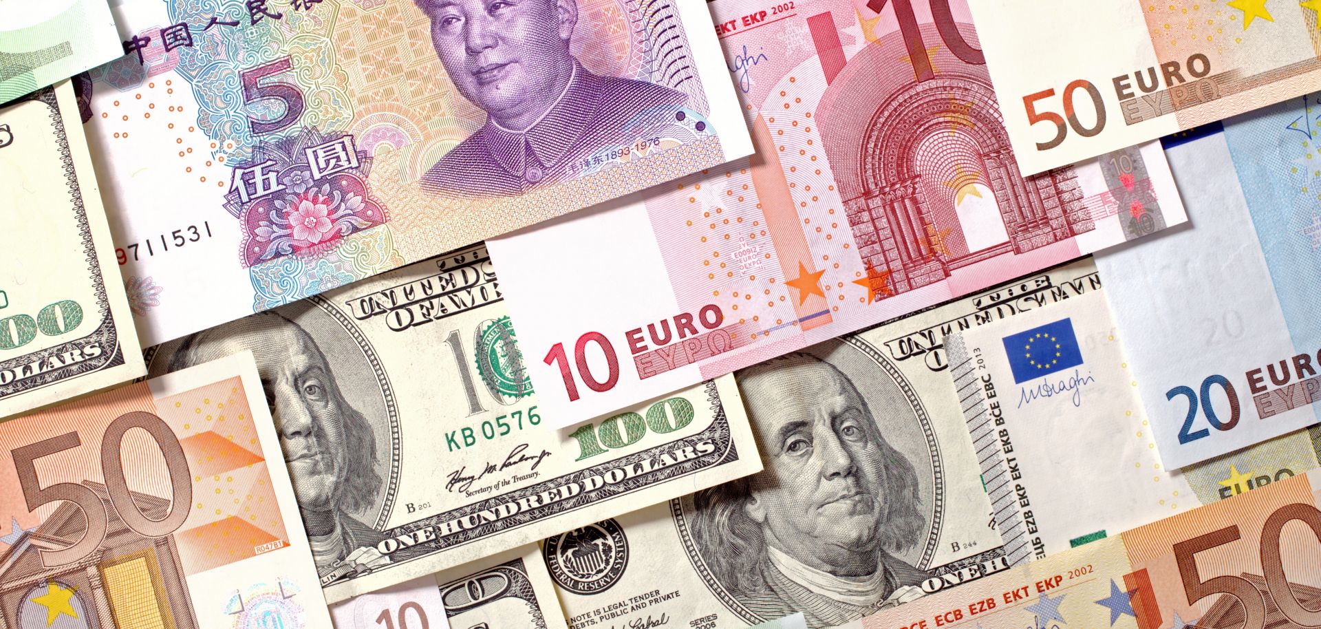 This photo illustration displays currencies of China, the European Union and the United States.