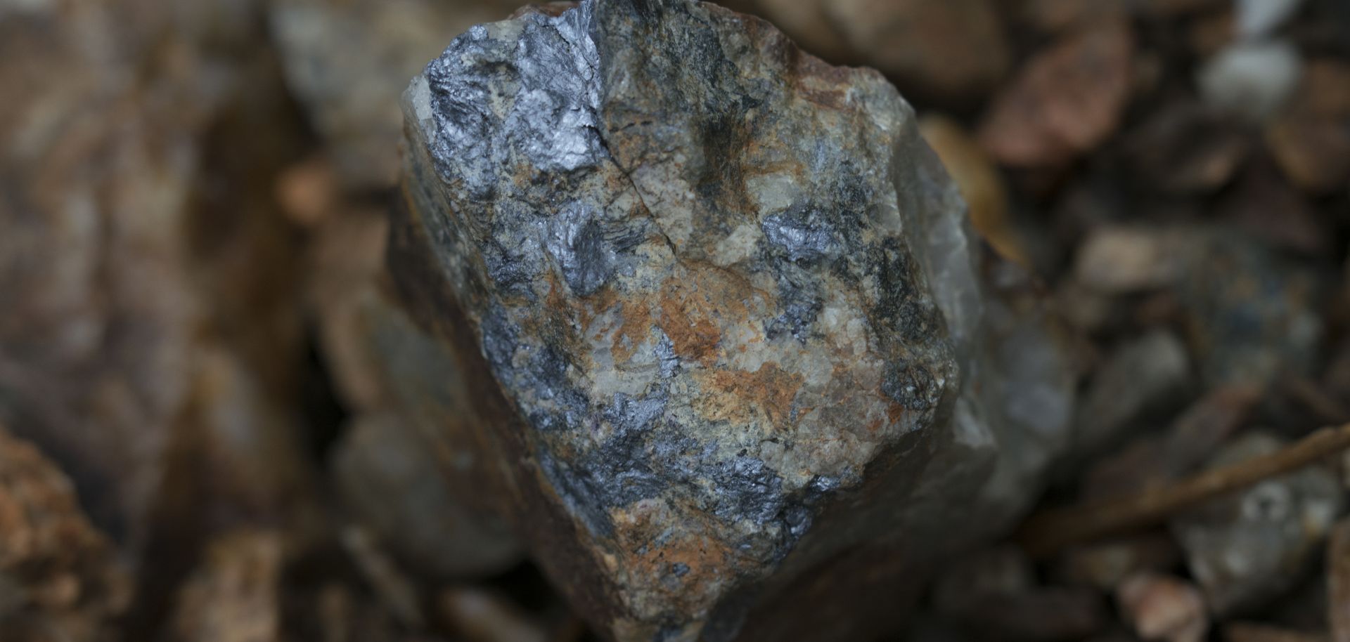 Dark colored mineral Molybdenite and the metal contained within the mineral called Molybdenum.