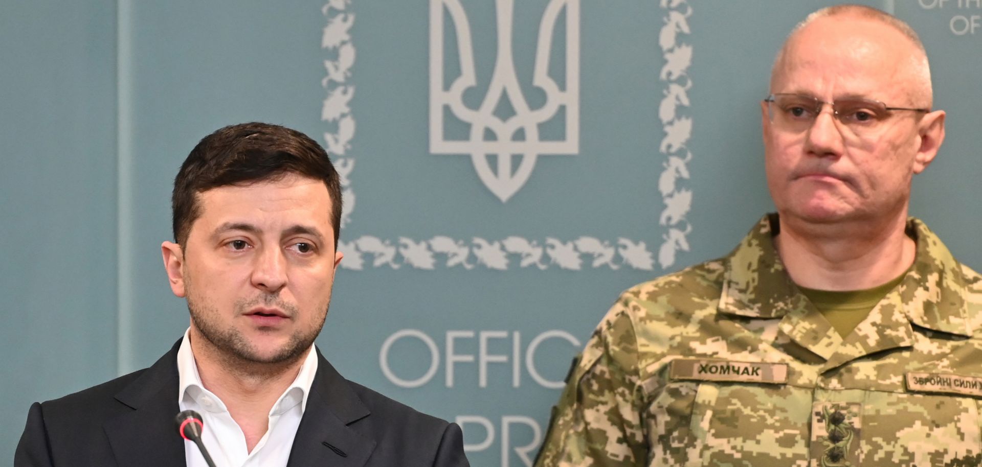 Ukrainian President Volodymyr Zelenskiy speaks following an outbreak of violence with pro-Russian separatists in eastern Ukraine on Feb. 18, 2020. Ruslan Khomchak, the commander of Ukraine's armed forces, stands behind Zelenskiy. 