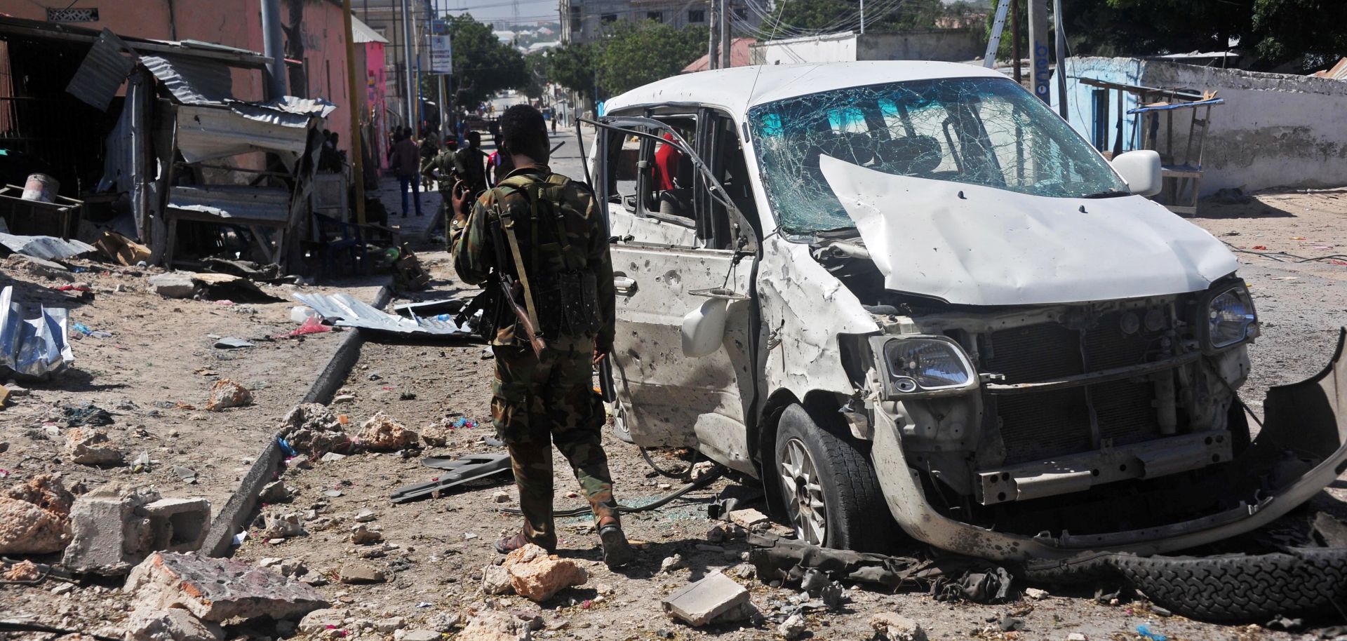 A Somali soldier stands at the scene of a car bomb attack conducted by al Qaeda affiliate al Shabaab near the Peace Hotel in Mogadishu on Jan. 2, 2017.
