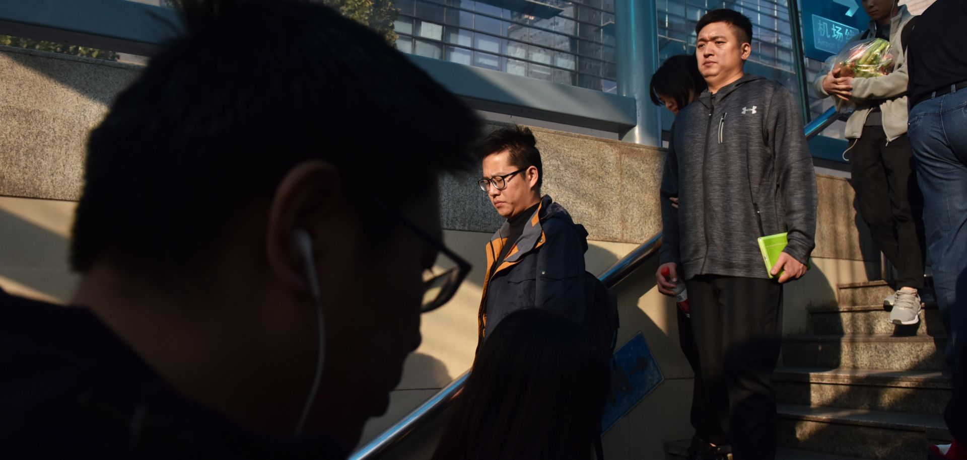 People walk into a subway station in Beijing on Oct. 19, 2018.