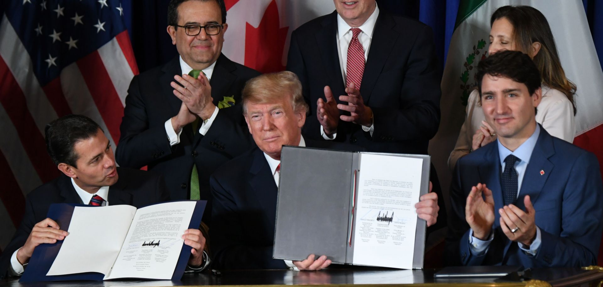 Mexican President Enrique Pena Nieto (left), U.S. President Donald Trump (center) and Canadian Prime Minister Justin Trudeau sit together after signing a new free trade agreement in Buenos Aires, Argentina, on Nov. 30.