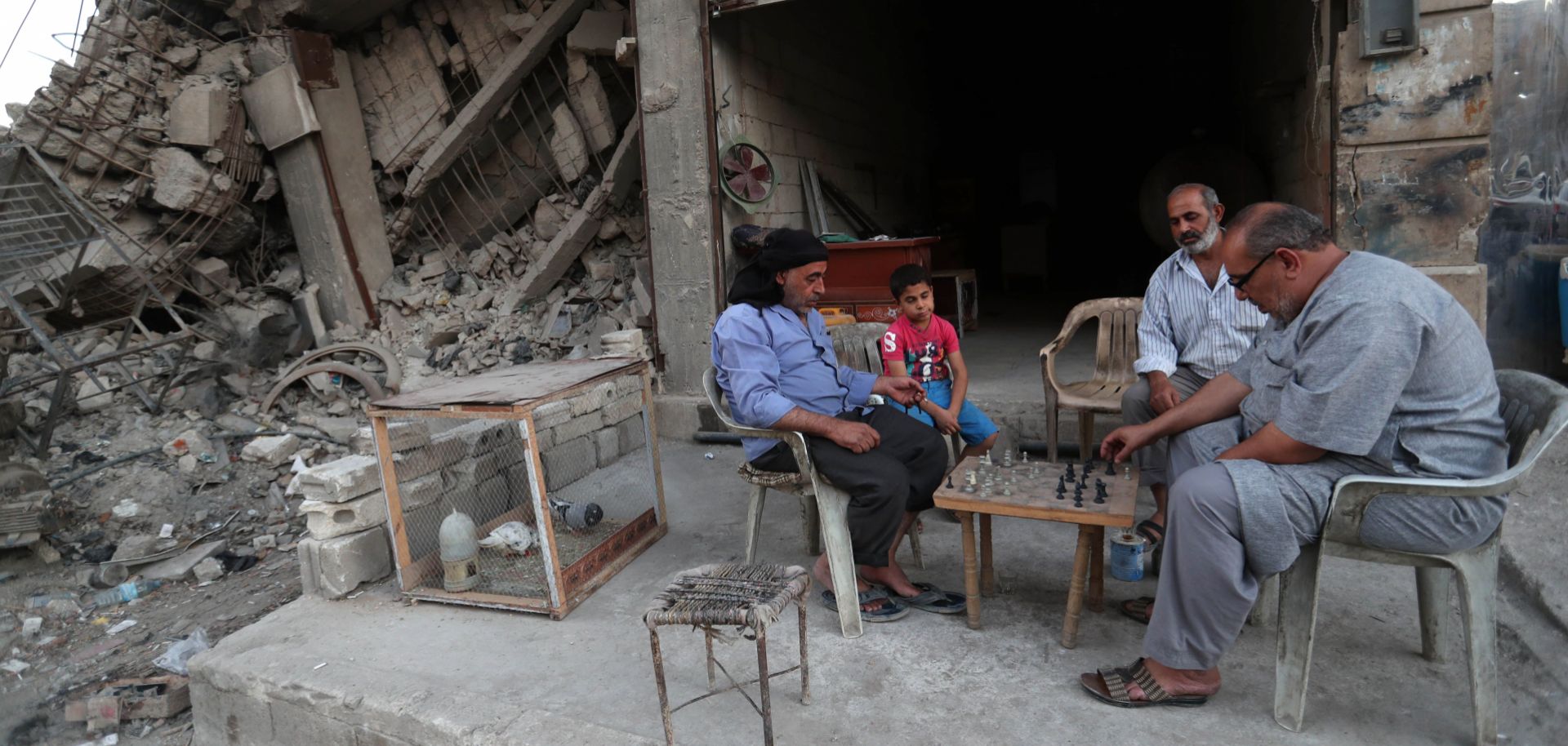 A boy watches a chess game outside a shop in northern Idlib province, the last rebel stronghold in Syria.