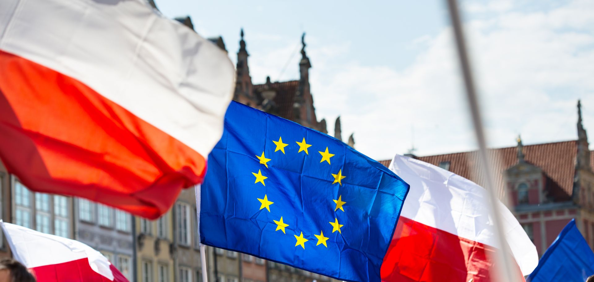 In this photograph, demonstrators carry Polish and European Union flags during a 2016 rally in Gdansk, Poland.