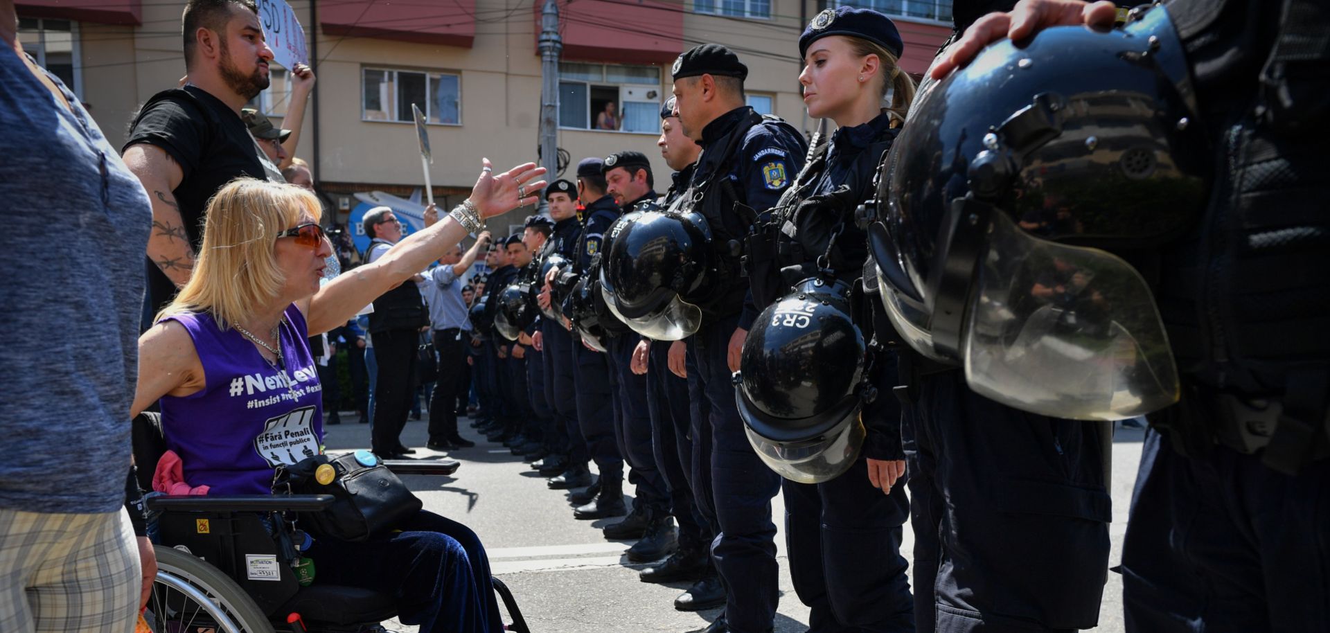 An anti-government protester shouts at supporters of Romania's Social Democratic Party (PSD) coming to attend an EU elections rally in Targoviste on May 19, 2019.