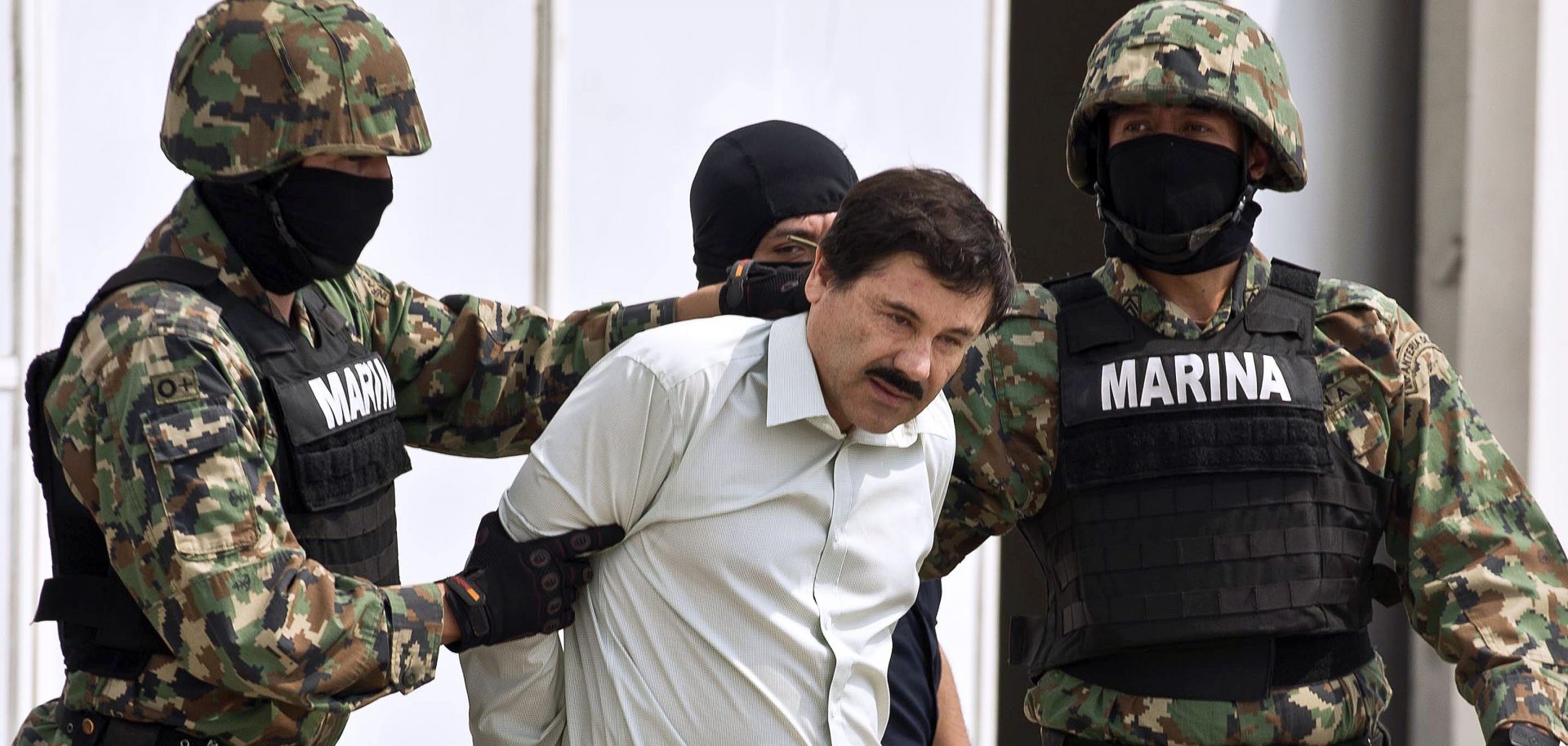 Mexican drug trafficker Joaquin Guzman Loera, aka "el Chapo Guzman" (C), is presented to the press on Feb. 22, 2014 in Mexico City.