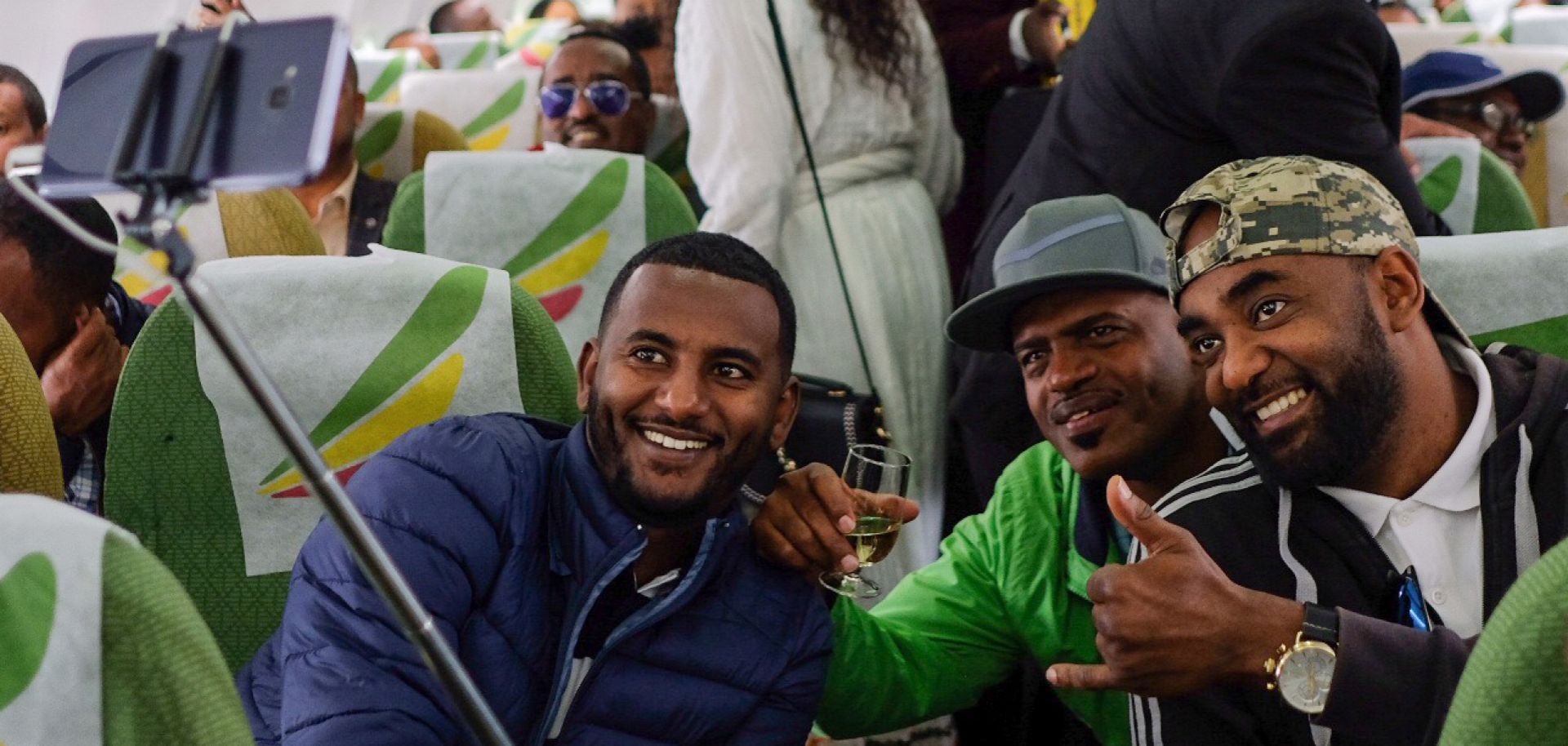 Passengers pose for a selfie inside an Ethiopian Airlines flight on July 18, 2018. The trip was the first commercial flight between the Ethiopian and Eritrean capitals in two decades.