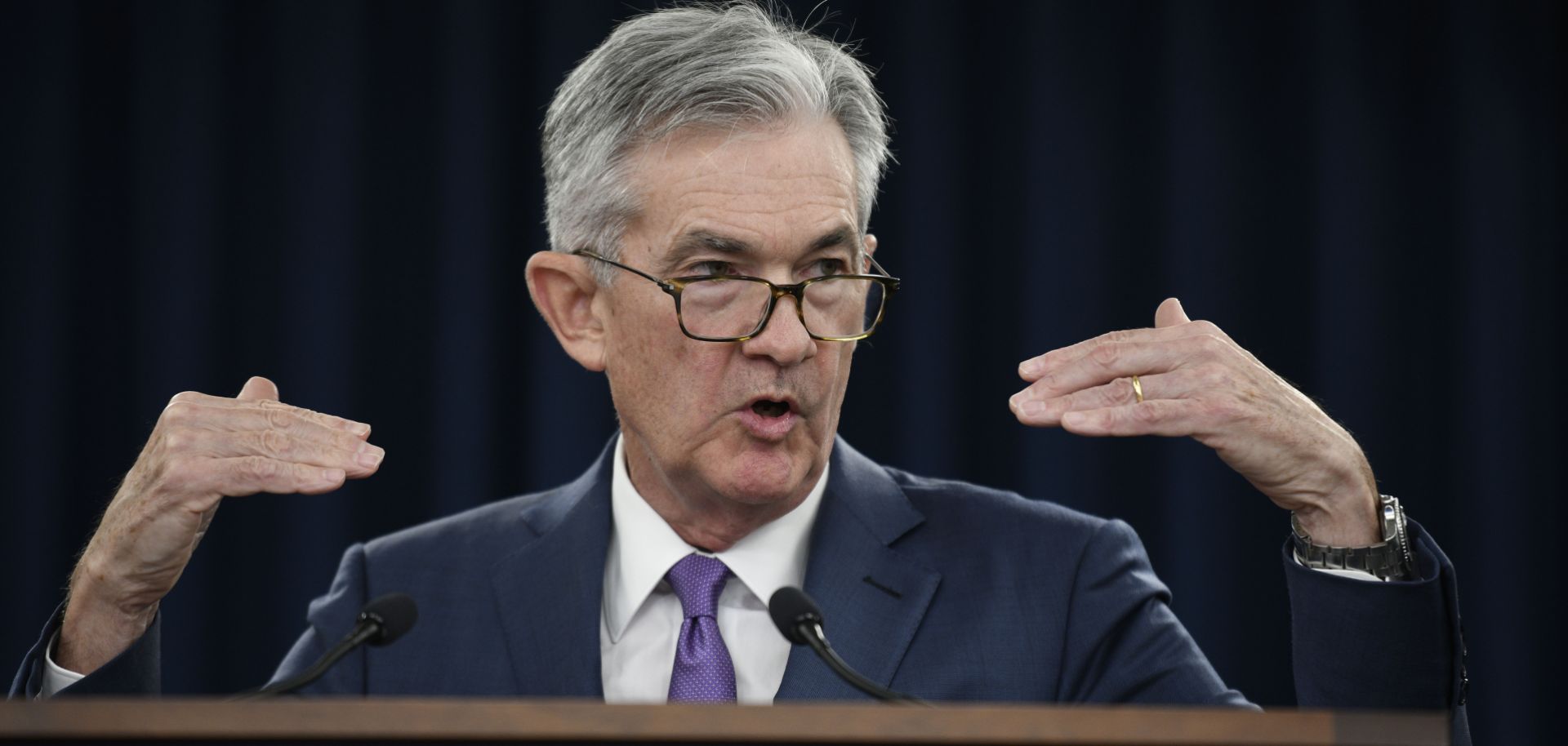 This image shows Jerome Powell, chairman of the U.S. Federal Reserve, delivering news about the central bank's decision to cut its benchmark interest rate.