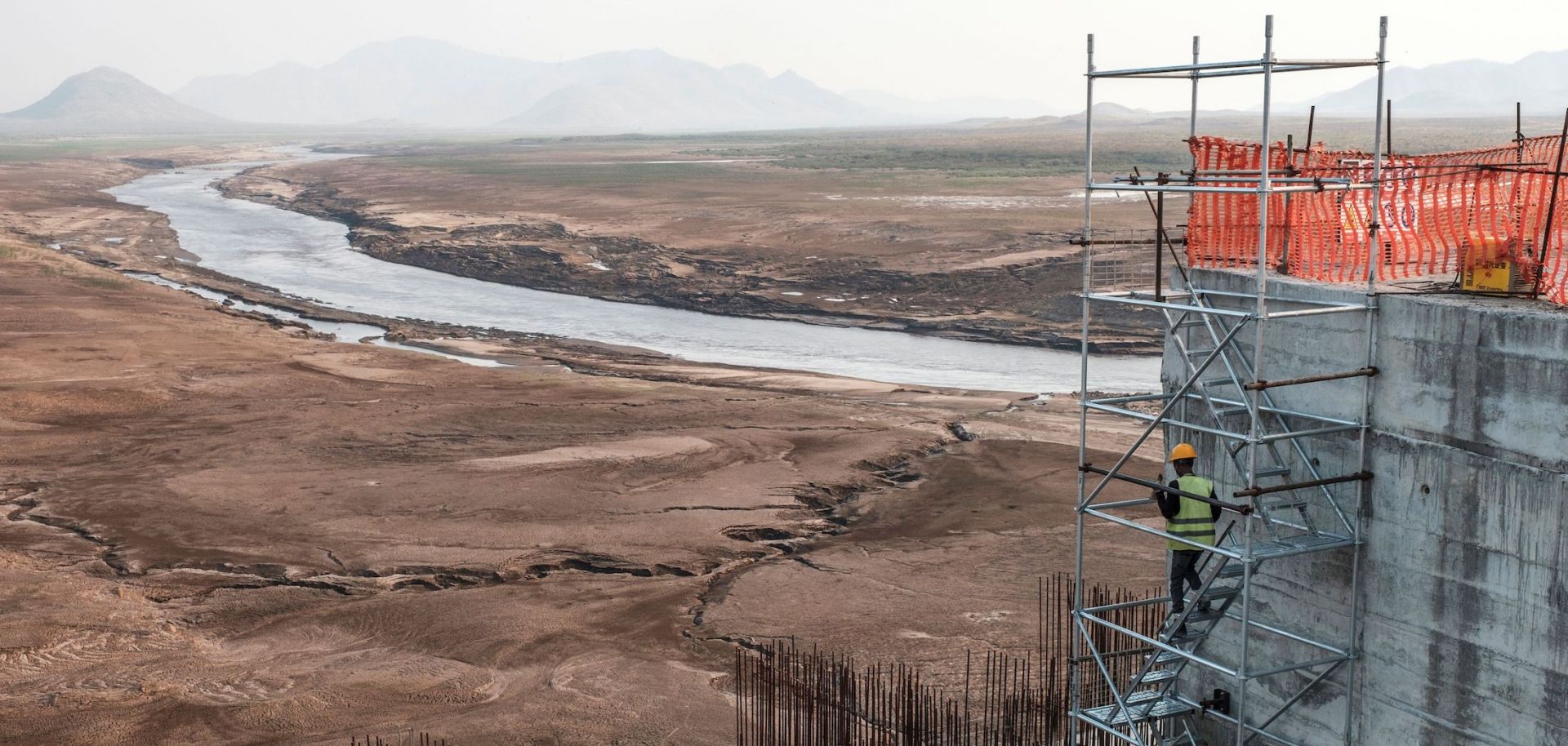 A worker goes down a construction ladder at the Grand Ethiopian Renaissance Dam on the Blue Nile in Ethiopia on Dec. 26, 2019. 