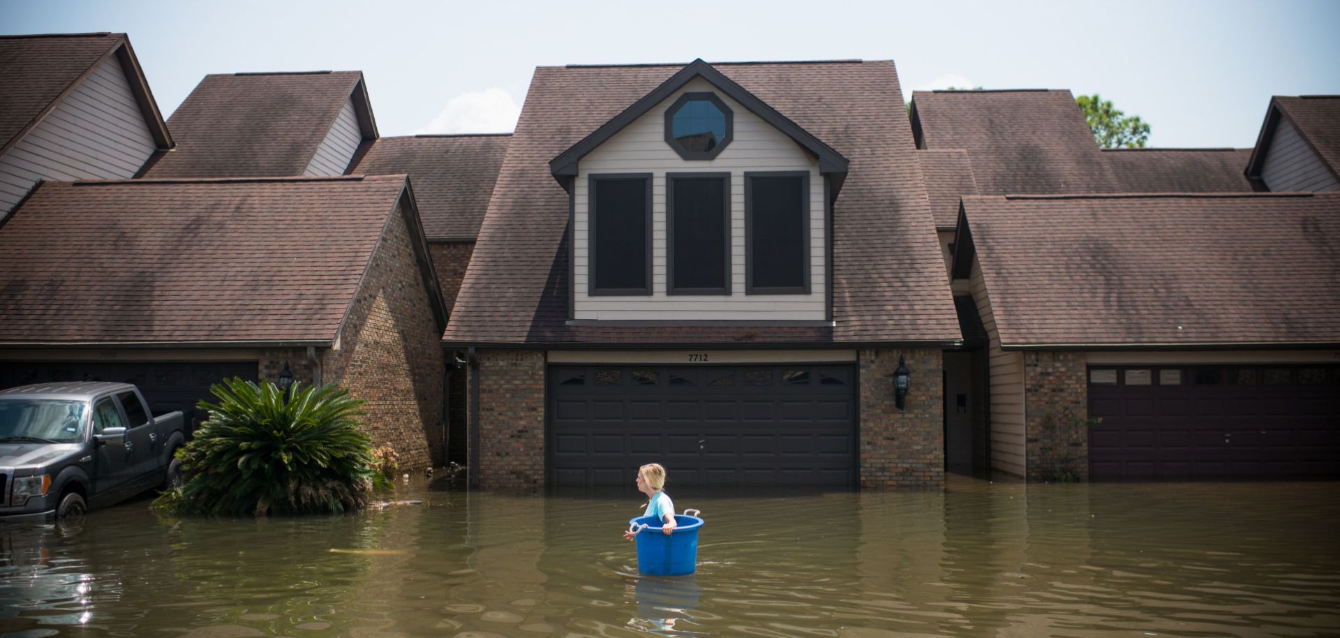 A woman tries to recover items from her flooded home in Port Arthur, Texas, in the wake of Hurricane Harvey.