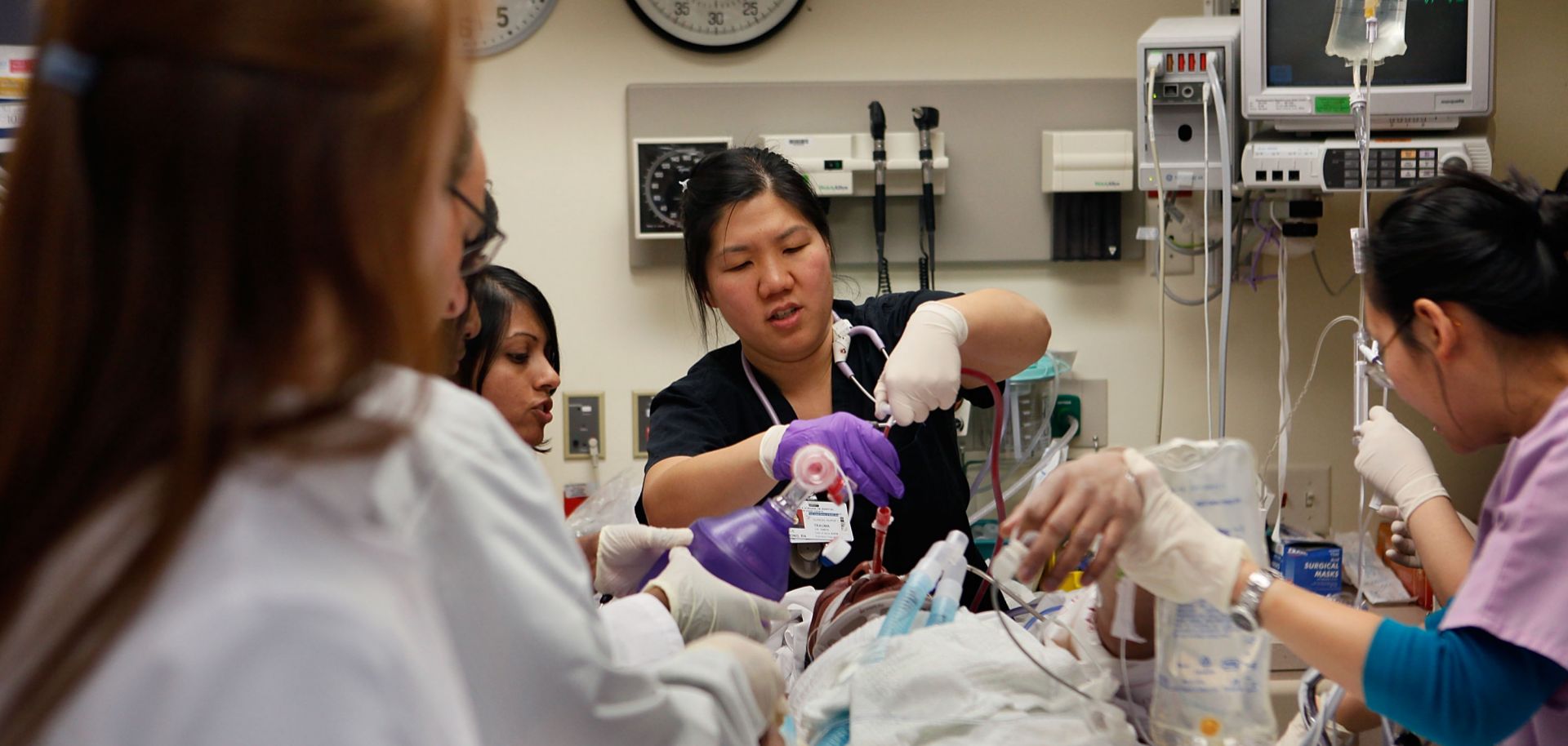 Doctors and nurses in a Chicago hospital's trauma unit work to revive a man hit by a car.