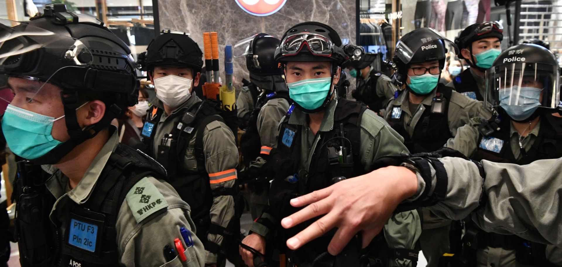 Riot police wear face masks, as a precautionary measure against the COVID-19 coronavirus, as they carry out a crowd dispersal operation in a shopping mall during a protest by pro-democracy supporters in the town of Shatin in Hong Kong on May 1, 2020.