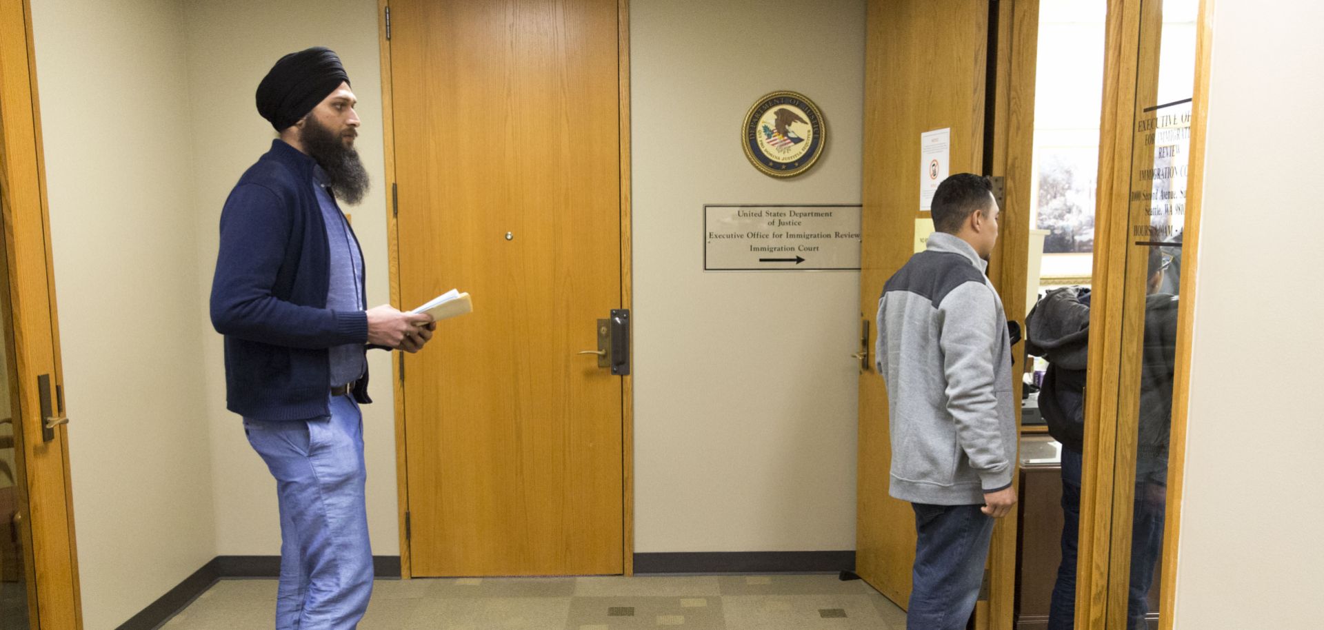 An asylum seeker waits in a security line for his immigration hearing in Seattle, Washington, on Jan. 11, 2017.