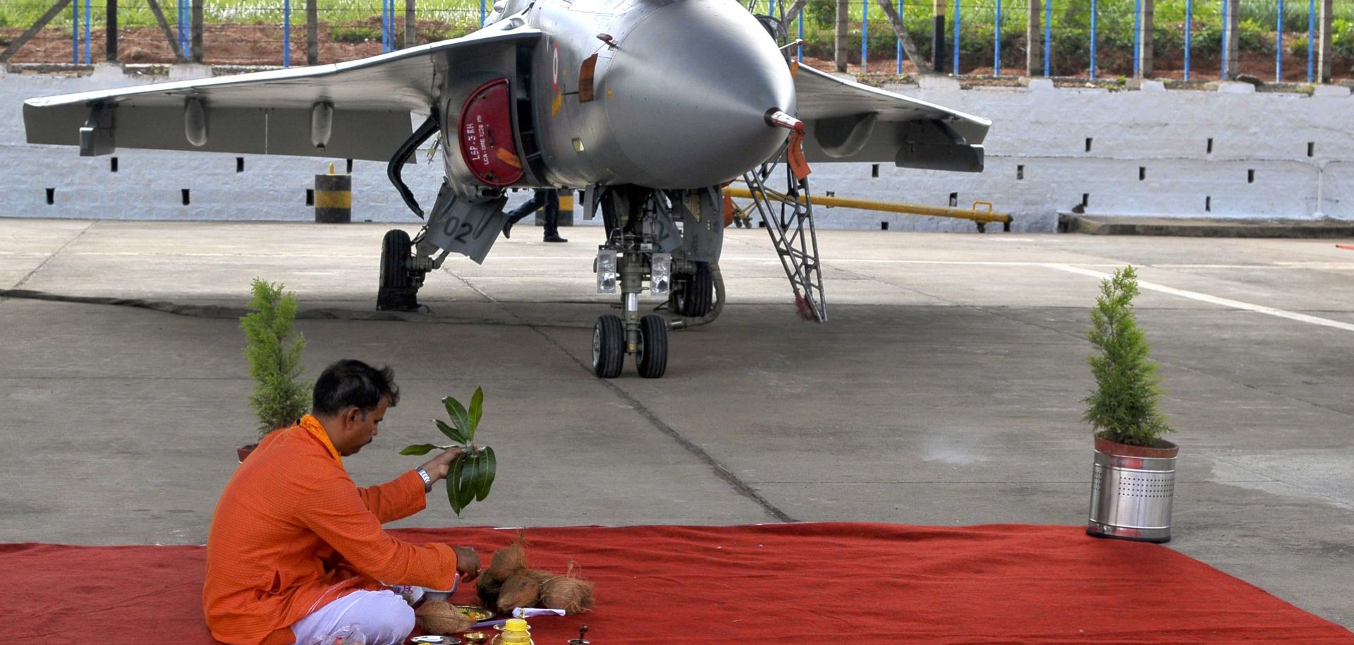 A ceremony, complete with a Hindu priest, marks the commissioning of a new Indian fighter jet in Bangalore.