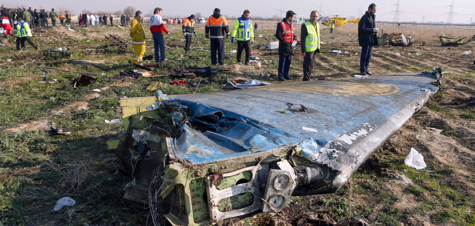 Teams examine the scene of a Ukrainian airliner that crashed being unintentionally targeted by Iranian air defenses shortly after takeoff in Tehran on Jan. 8, 2020.