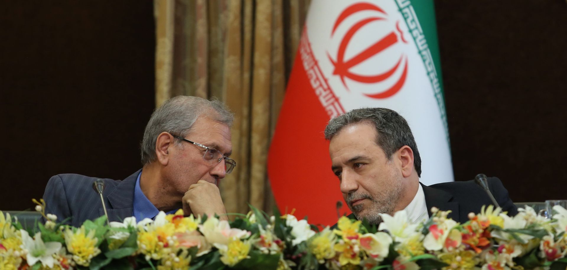 A handout picture provided by the Iranian presidency on July 7, 2019, shows Iran's government spokesman Ali Rabiei, left, and Deputy Foreign Minister Abbas Araghchi during a news conference in Tehran.