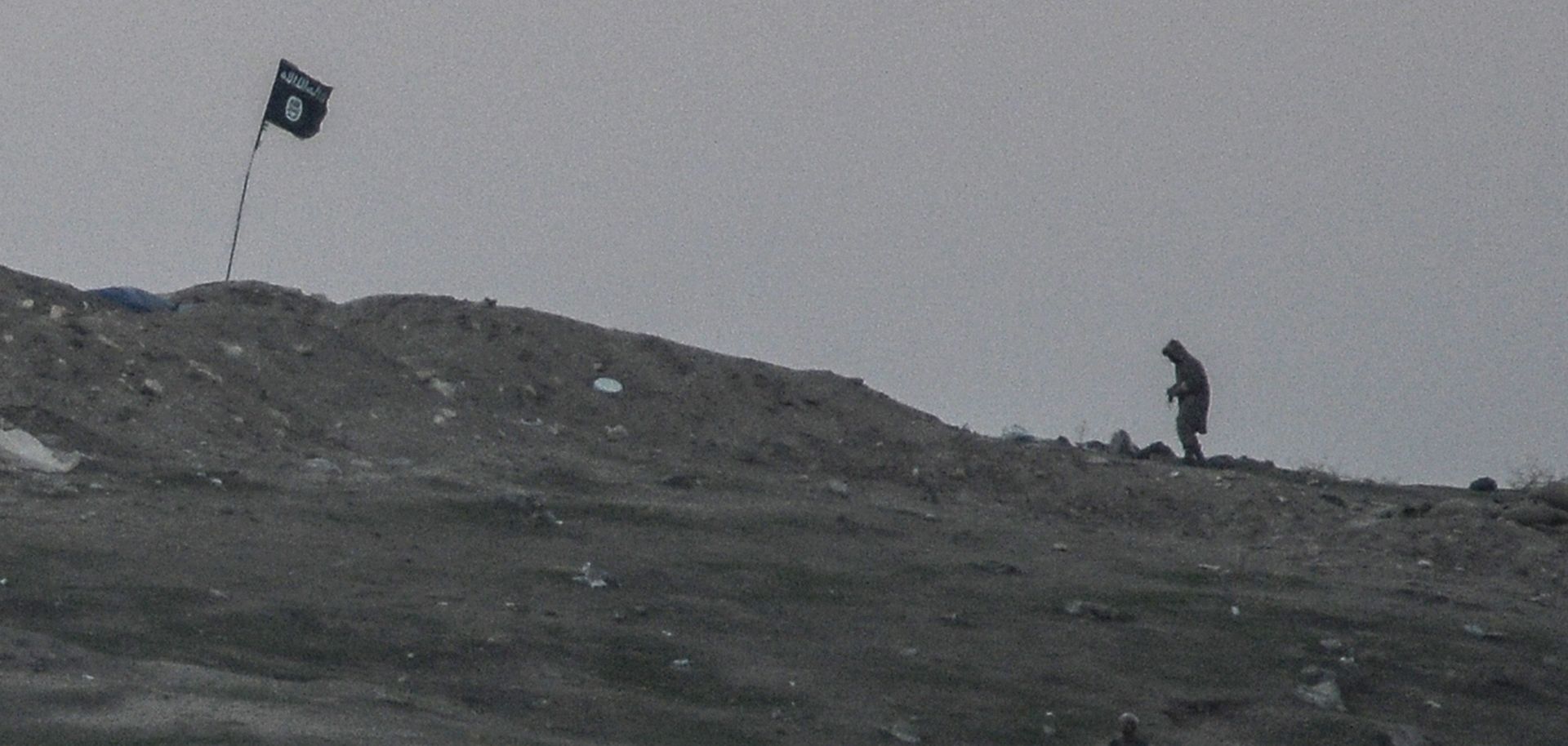 Militants of Islamic State are seen just before the explosion of airstrike on Tilsehir hill near the Turkish border on Oct. 23, 2014, at Yumurtalik village, in Sanliurfa province. 