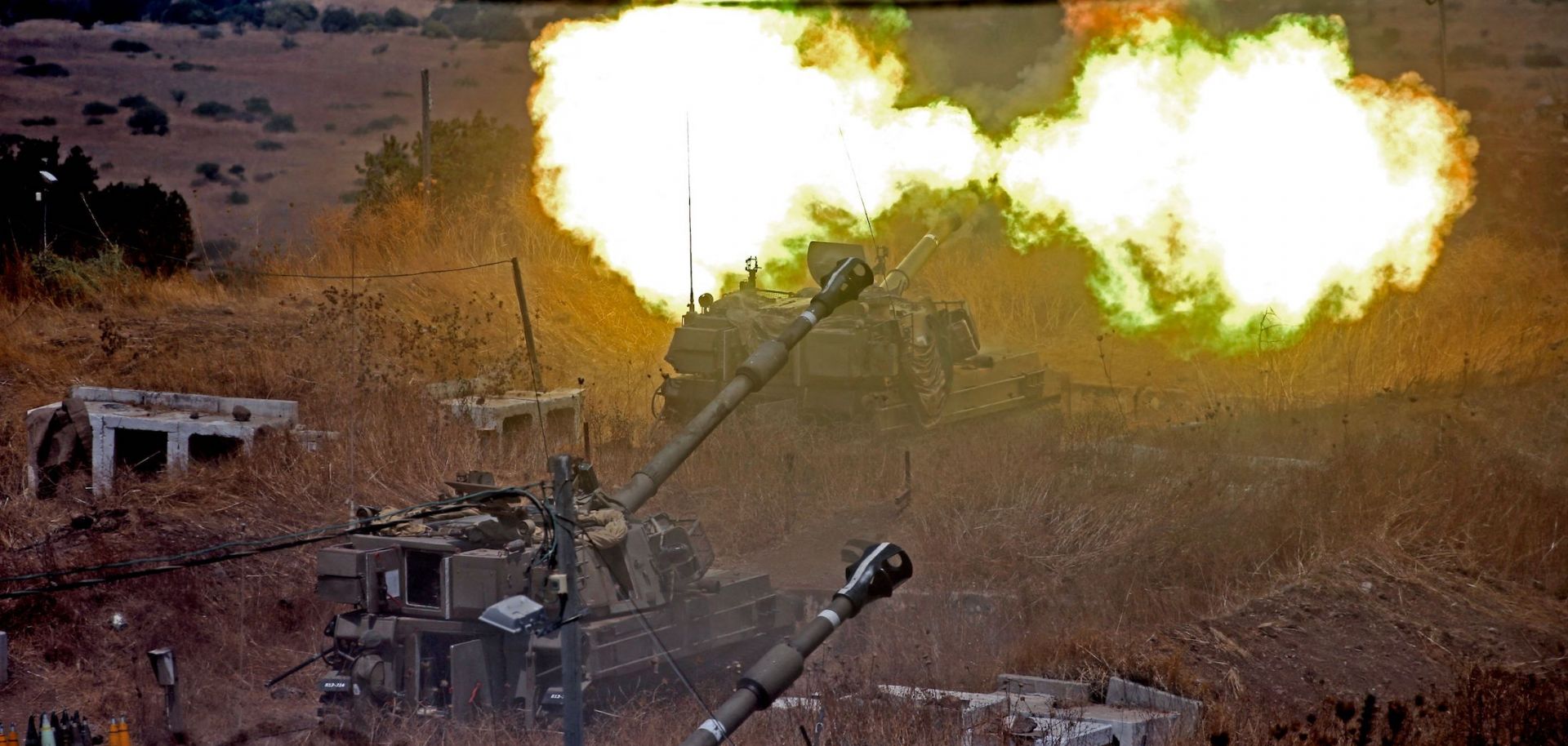 Israeli self-propelled howitzers fire toward Lebanon on Aug. 6, 2021, from a position near the northern Israeli town of Kiryat Shmona following rocket fire from the Lebanese side of the border.