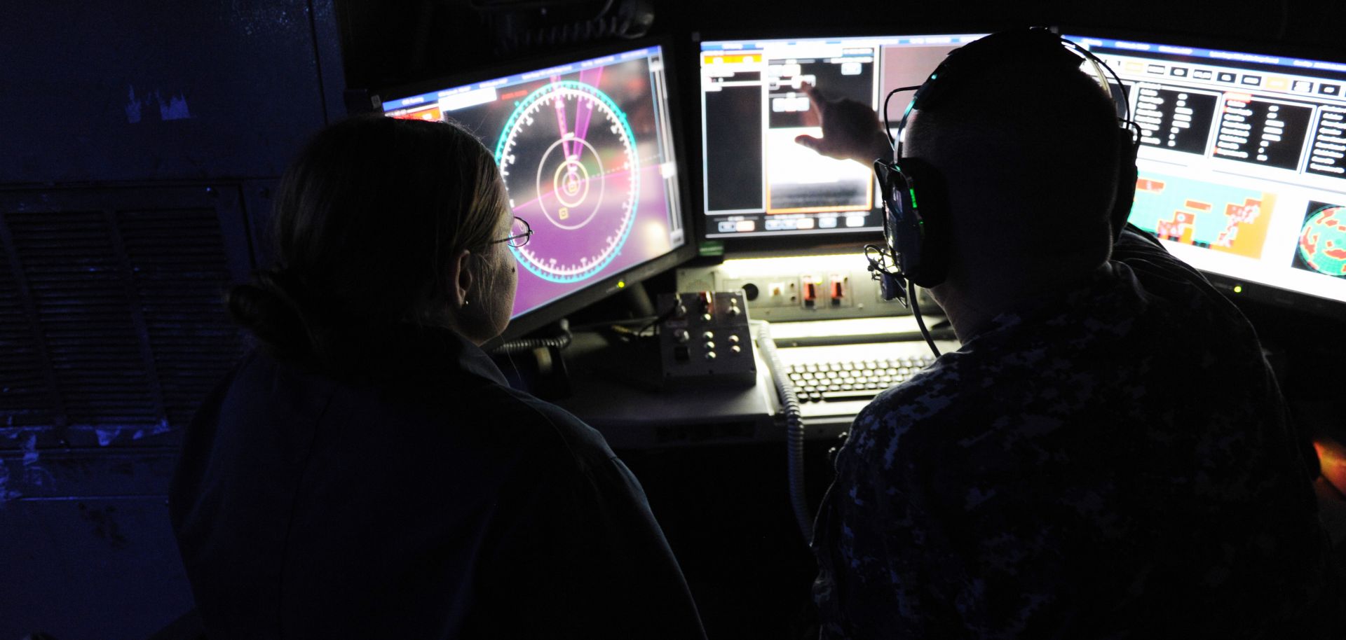 Sailors aboard the USS Ponce demonstrate a ship-mounted laser weapon system.