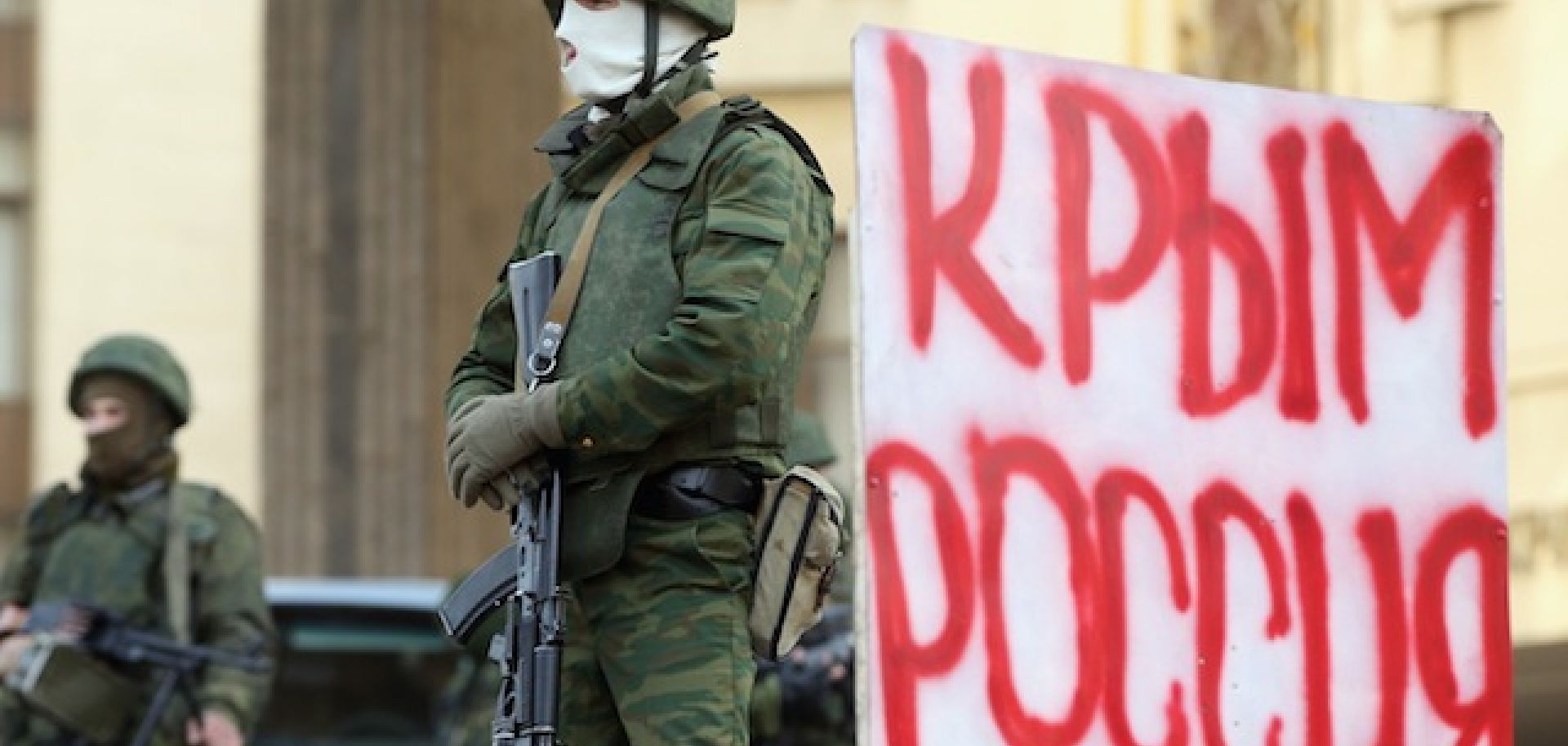 Unidentified soldiers guard the Crimean parliament building