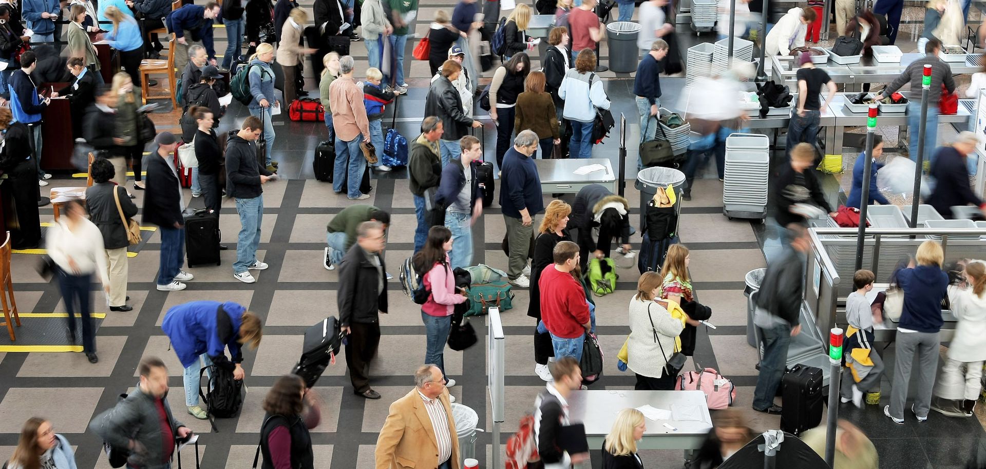 Travelers move through a security line at Denver International Airport the day before Thanksgiving. But remarkably, many Americans insist that they have little to be thankful for.